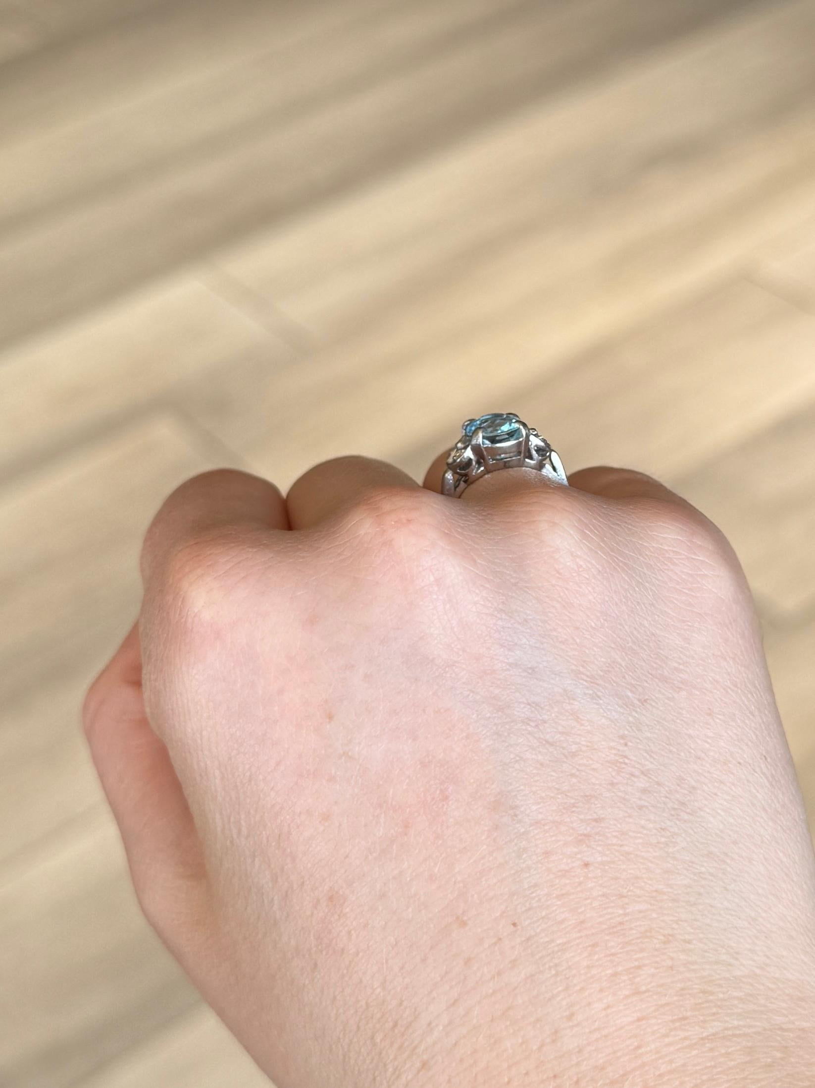 Striking blue topaz set simply in platinum and sat either side is a duo of diamonds. Topaz measures approx 2carat and the diamond total is 12pts. 

Ring Size: H 1/2 or 4 
Topaz Dimensions: 9.5x8mm
Height Off Finger: 6mm

Weight: 5.1g