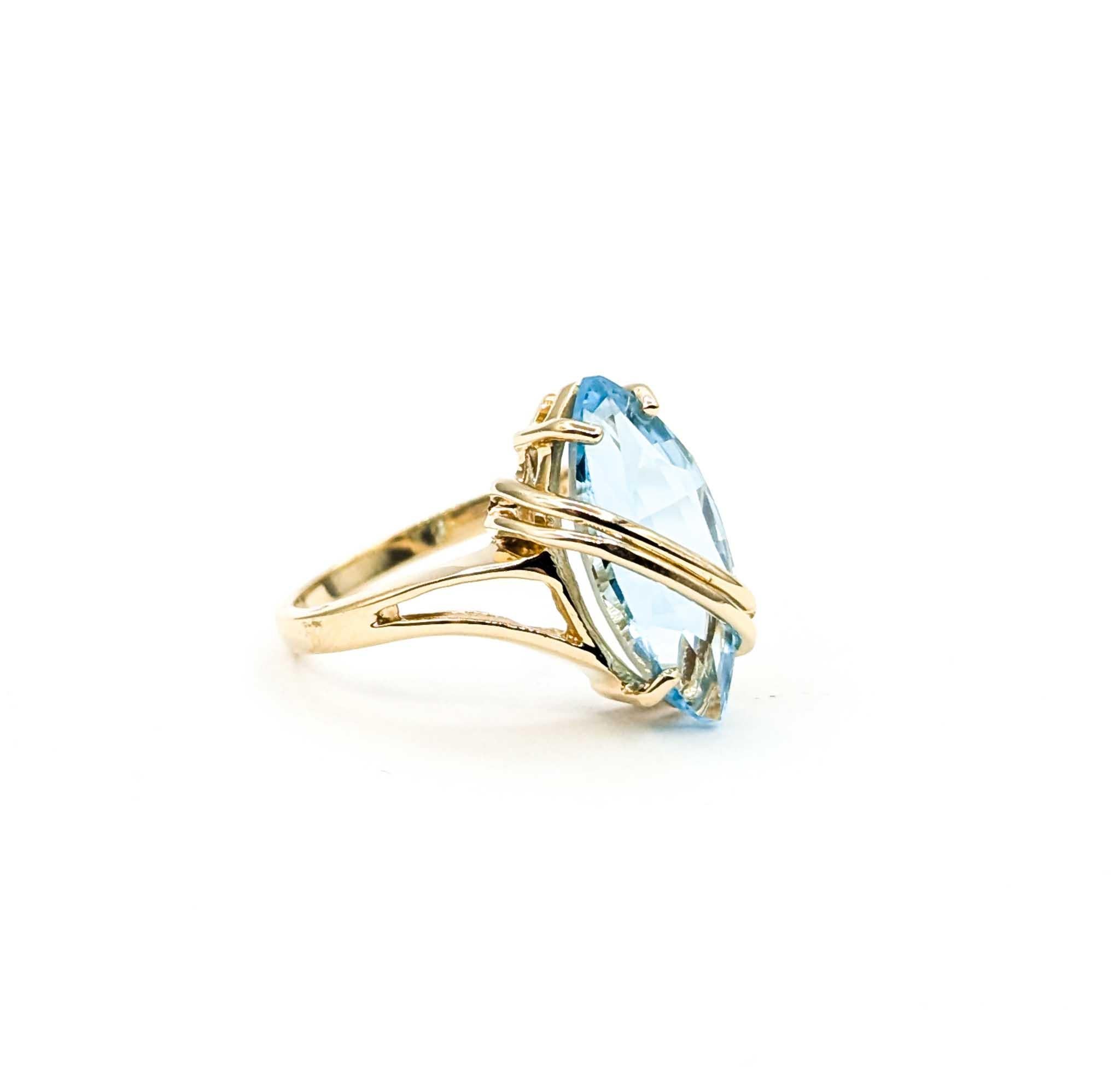 This vintage statement ring features a striking 3.50 carat marquise-cut blue topaz, prong set to showcase its vibrant, sky-blue brilliance. The elongated marquise shape creates an elegant and eye-catching centerpiece, while the polished 14k yellow
