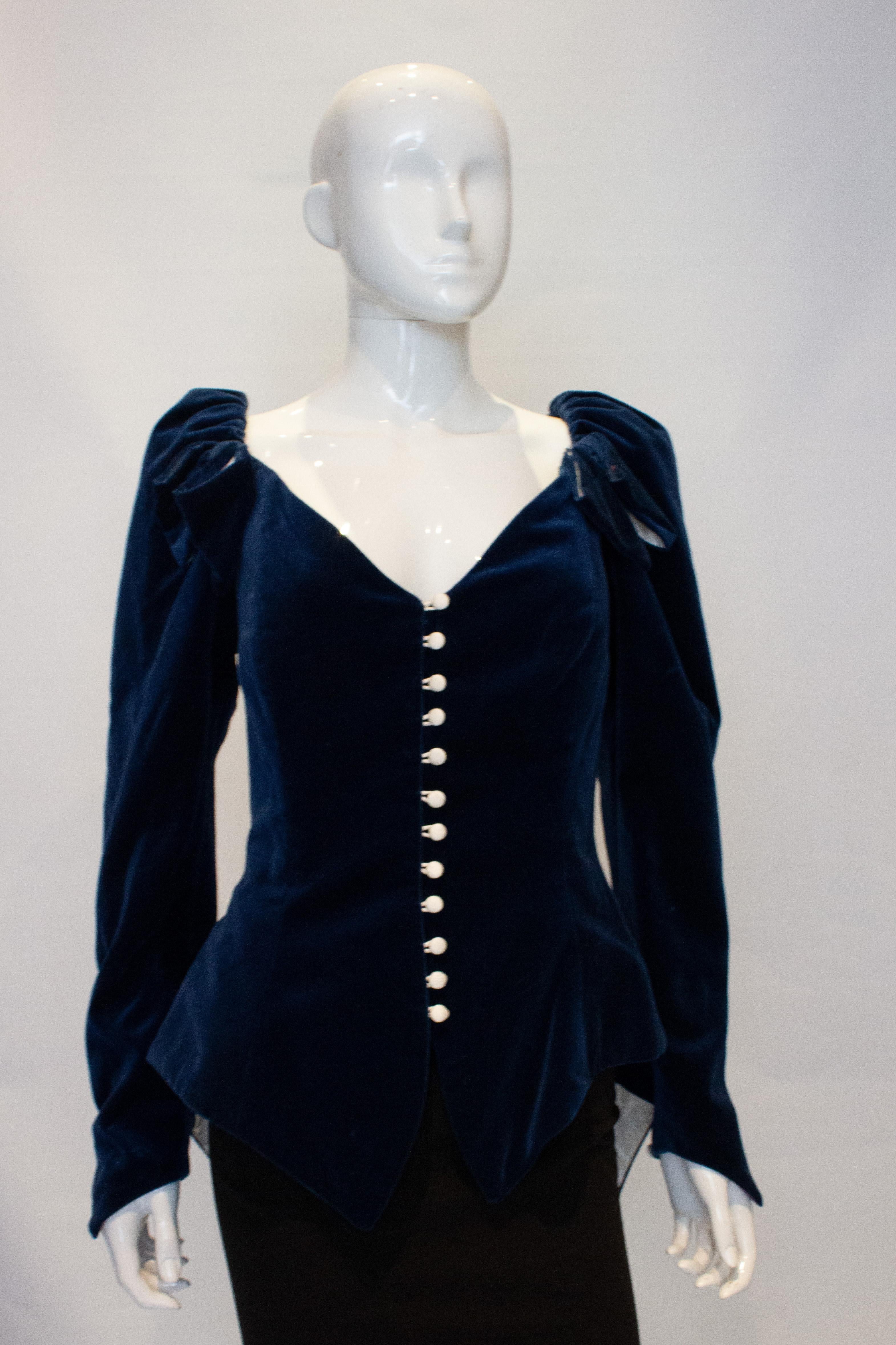 A fun vintage jacket in blue velvet by Ronalo Joyce.  The jacket has boning and white  button front fastening, with a v neckline. it is longer at the back with bow detail, and can be worn on or off the shoulder.
Measurements: Bust 38'', length 35''