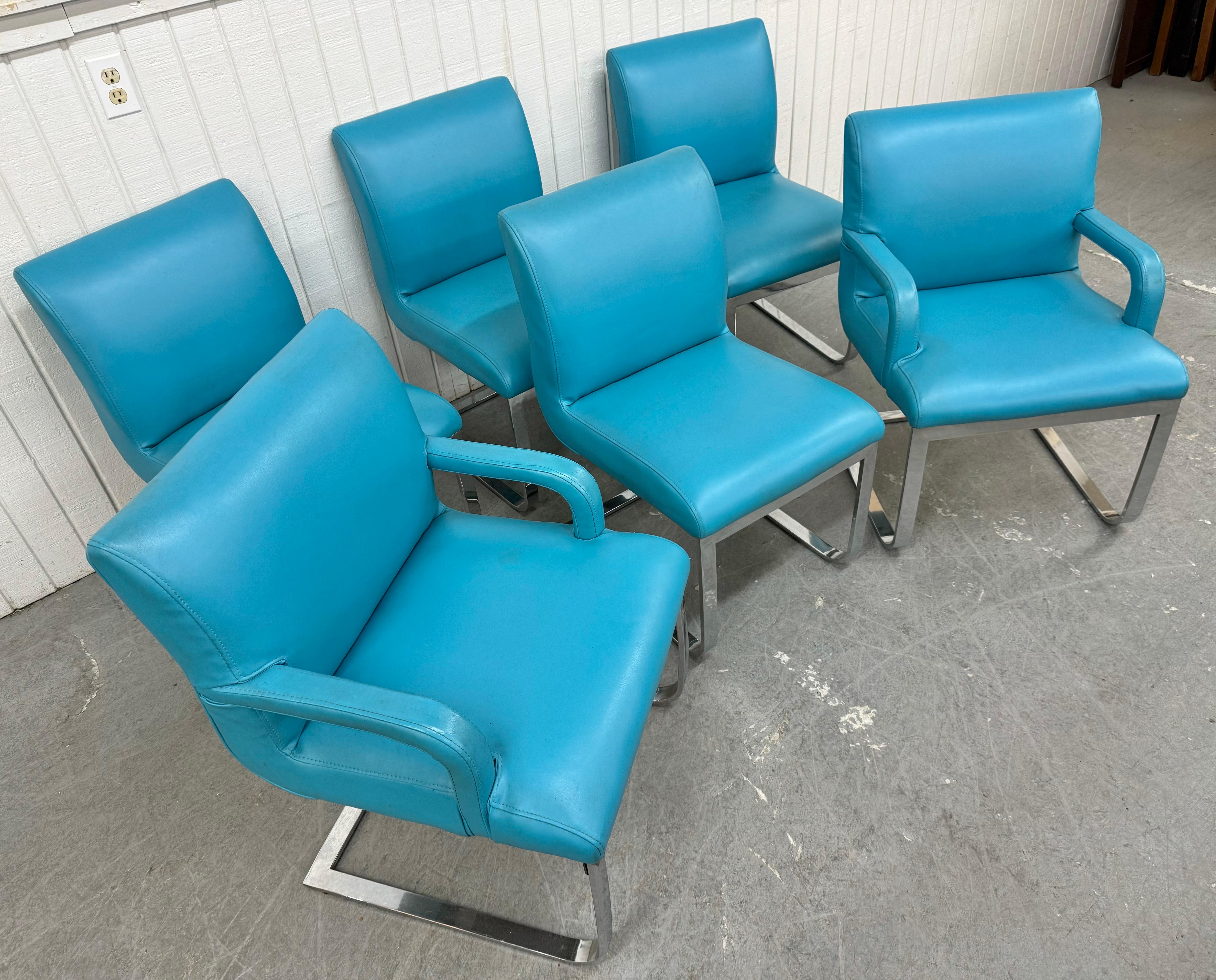 This listing is for a set of six Vintage Blue Vinyl Flat Bar Chrome Dining Chairs. Featuring two arm chairs, four side chairs, original blue vinyl upholstery, and a flat bar chrome base. This is an exceptional combination of quality and design!
