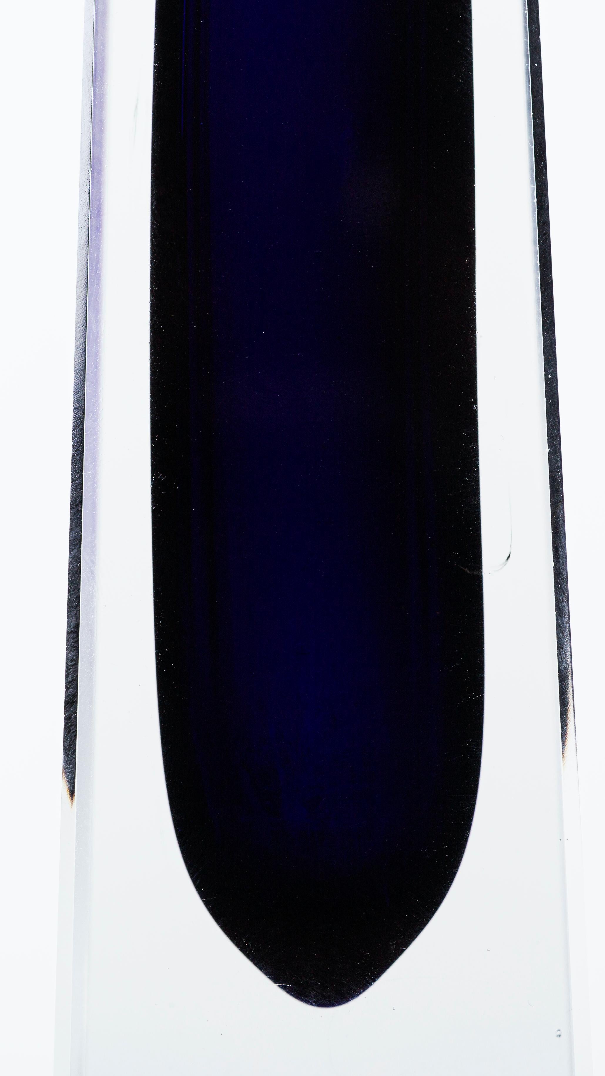 This blue/violet vase is an original glass vase by German manufacture 1960s, a tall, slender pyramid-shaped jar with a rectangular base.
The blue/violet color stands out from the transparent glass shirt.
Excellent conditions.
  