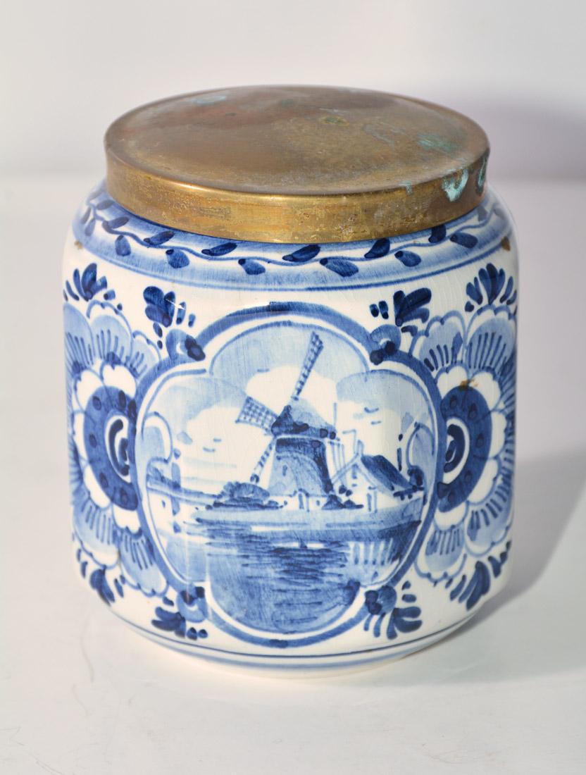 The vintage blue and white octagonal canister has a brass lid and is stamped 