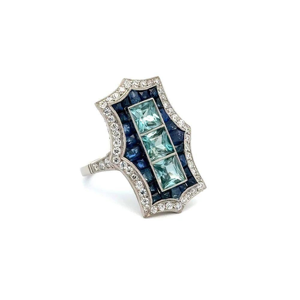 Simply Beautiful! Elegant and Finely detailed Blue Zircon Sapphire and Diamond Vintage Rectangular Platinum Statement Cocktail Ring. Centering 3 securely nestled Hand set Square Blue Zircon Gemstones, weighing approx. 2.56tcw, surrounded by