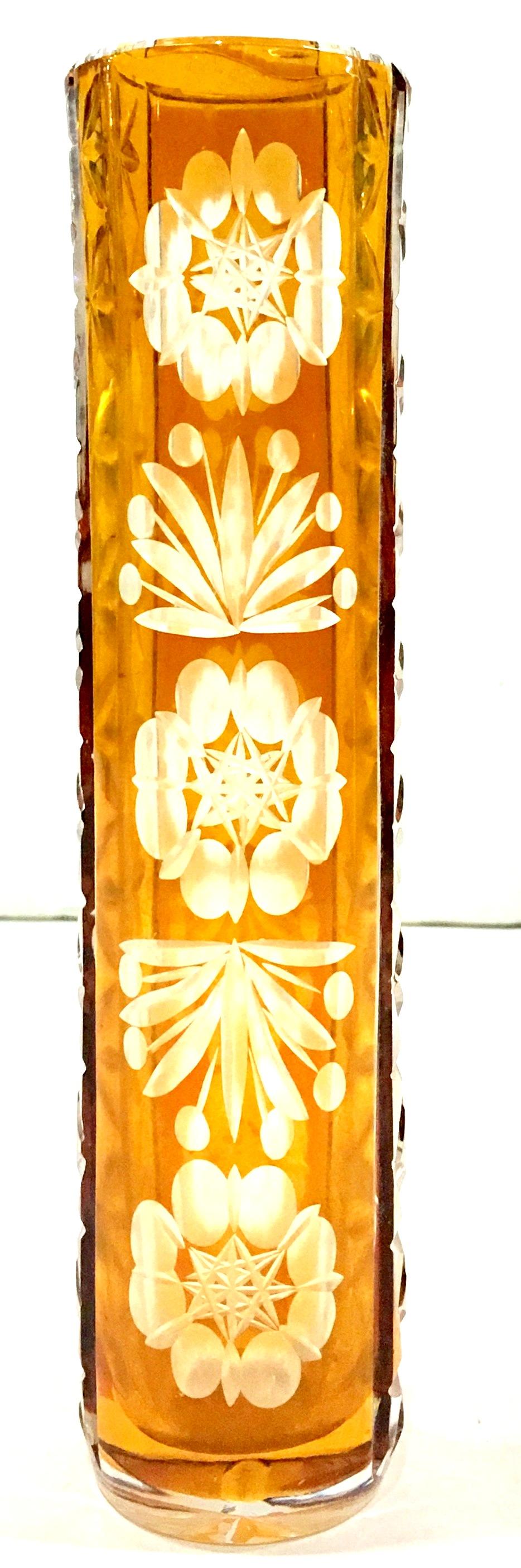 Mid-20th Century Bohemia crystal cut to color amber bud vase. Features a floral pattern.