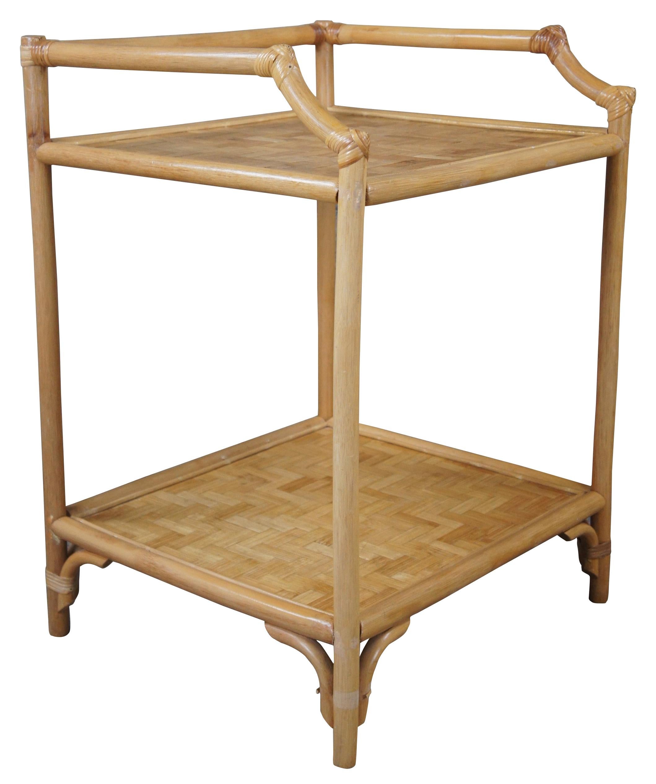 Vintage Hollywood Regency / Bohemian end table or plant stand, circa last quarter 20th century.  Features a bamboo frame with geometric rattan panels. 

20