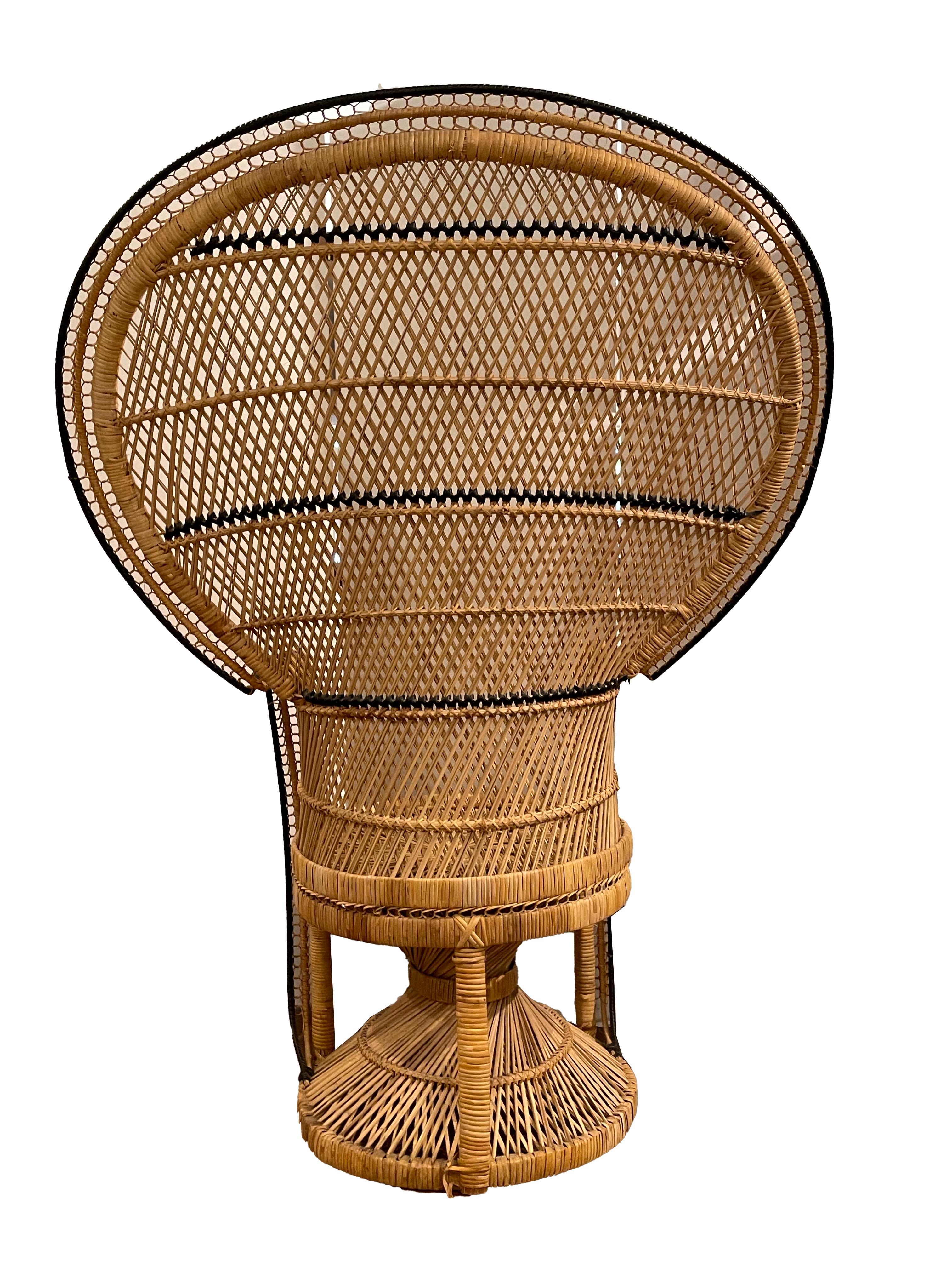 This vintage boho 1970's peacock chair is a great example of this era. The chair is in great condition with black detail woven into the rattan.