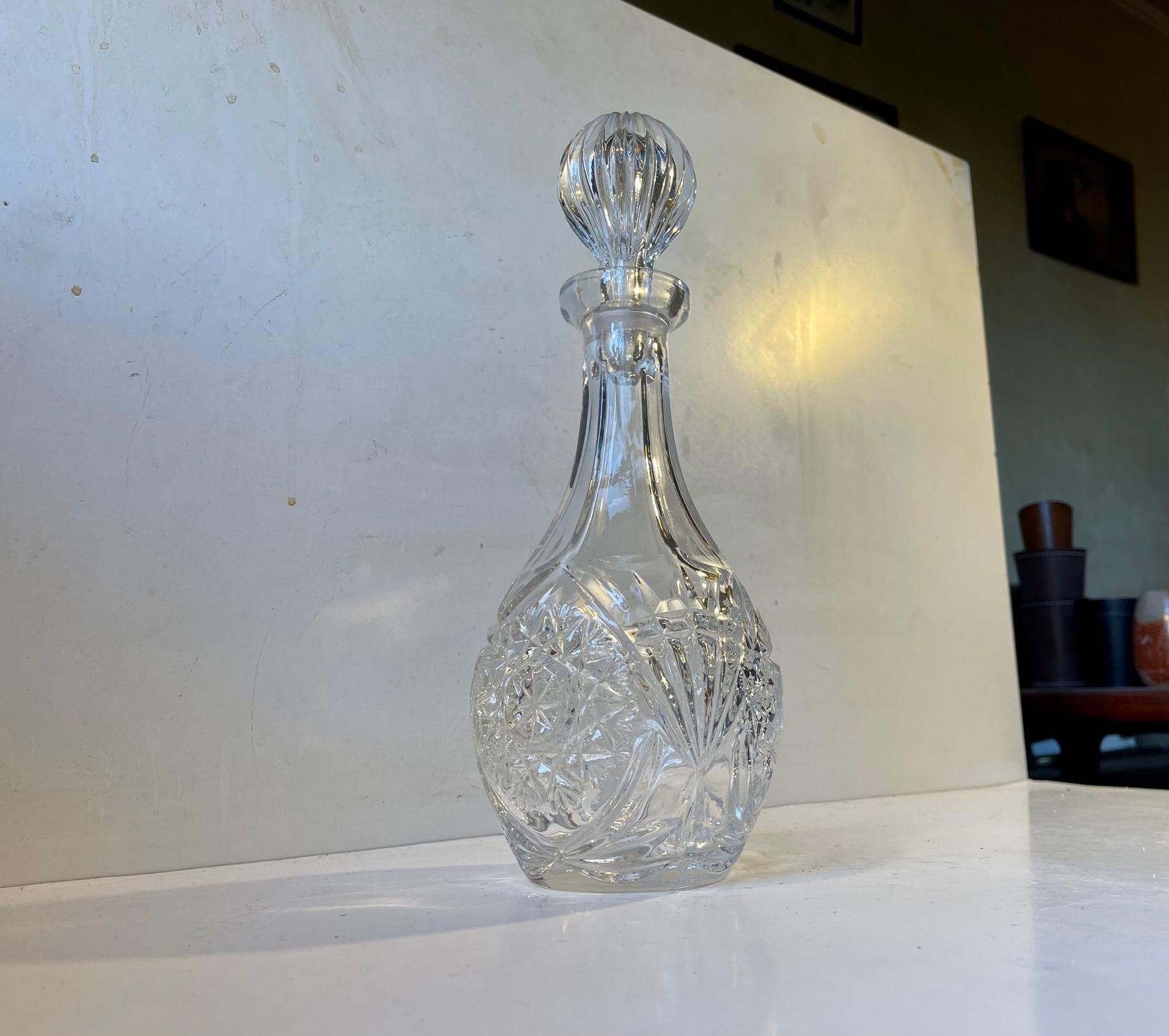 Decorative clear crystal decanter with fluted spherical stopper. Made in Bohemia/Czech Republic during the 1970s. NOS - new old stock and has never been in use. It has a capacity of 0.7 liters. Measure: Height: 31 cm.