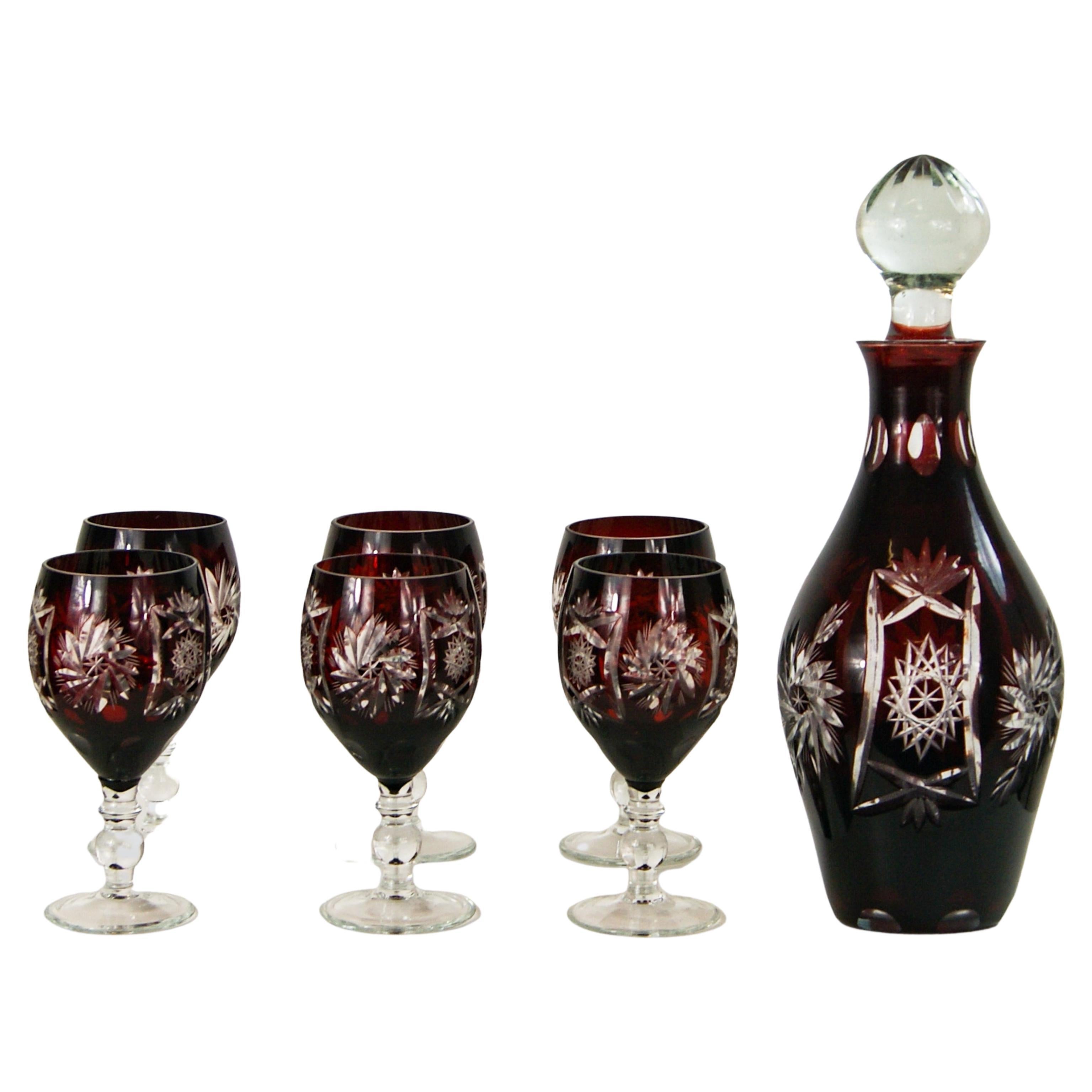 Bohemian / Czech cut glass decanter and wine glasses set.
Matching 8 piece set of ruby red cut to clear glass.
The stopper is in clear glass and bears the same cut glass design.

In very good vintage condition.
With some light surface scratches