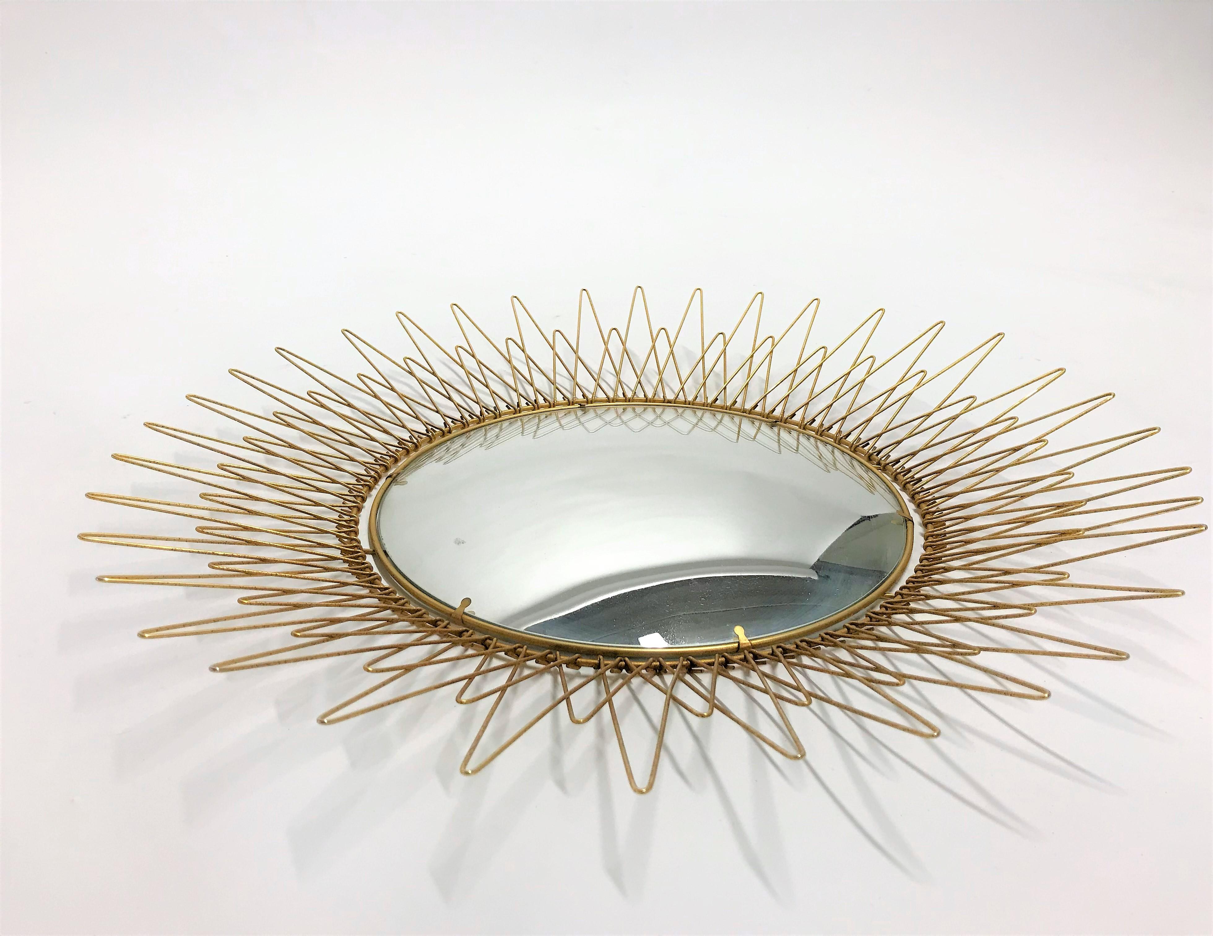 Metal sunburst mirror with convex mirror glass.

The golden mirror is in a very good condition.

1960s - made in Belgium.

Dimensions:
Diameter: 57 cm/ 22.5