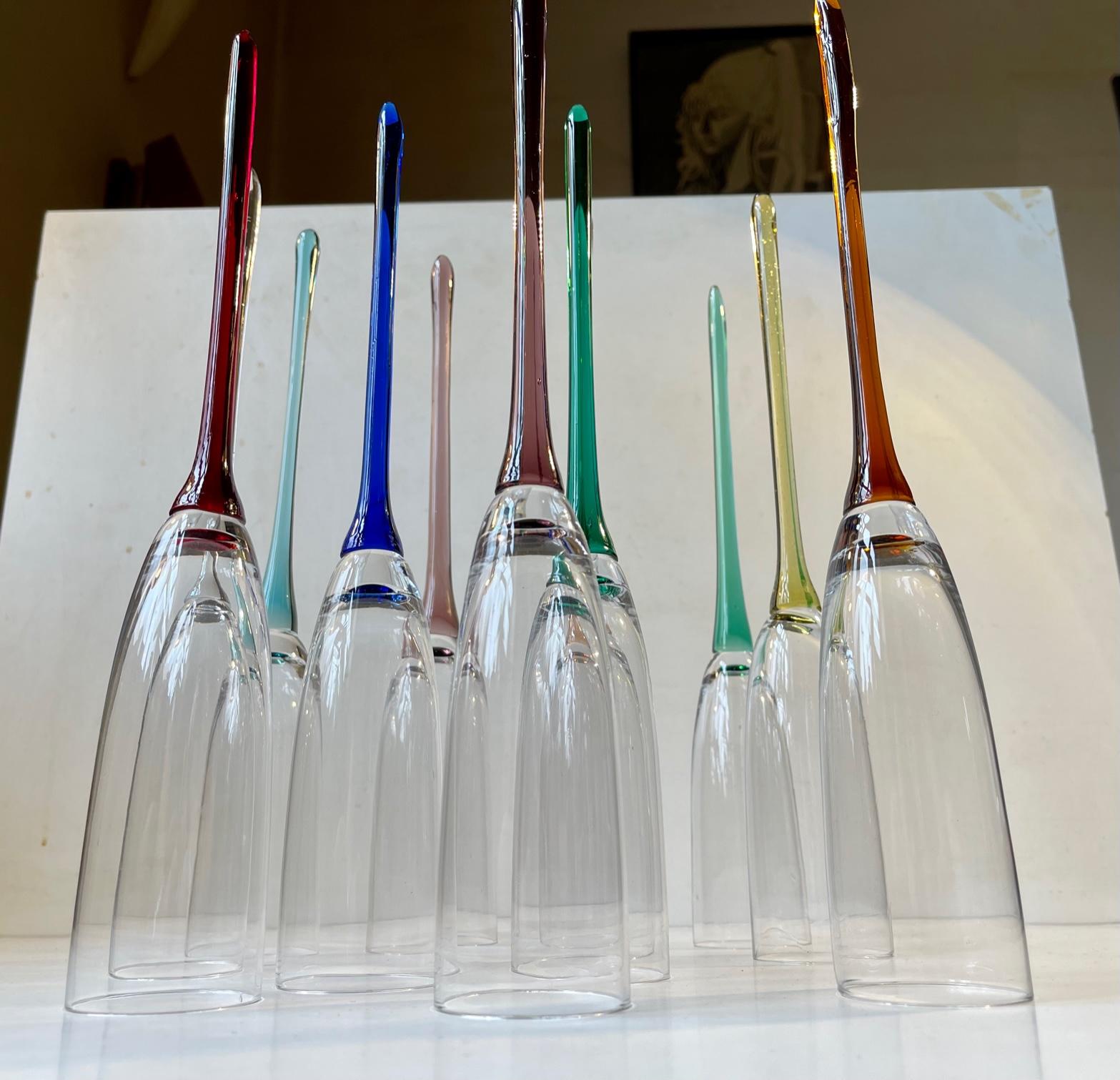 A set of 11 base-less champagne glasses with colored stems. Handmade in Bohemia/Czech Republic circa 1980-90. Measurements: height: 30 cm (slight variation), diameter: 5 cm (top). The price is for the lot - set of 11.