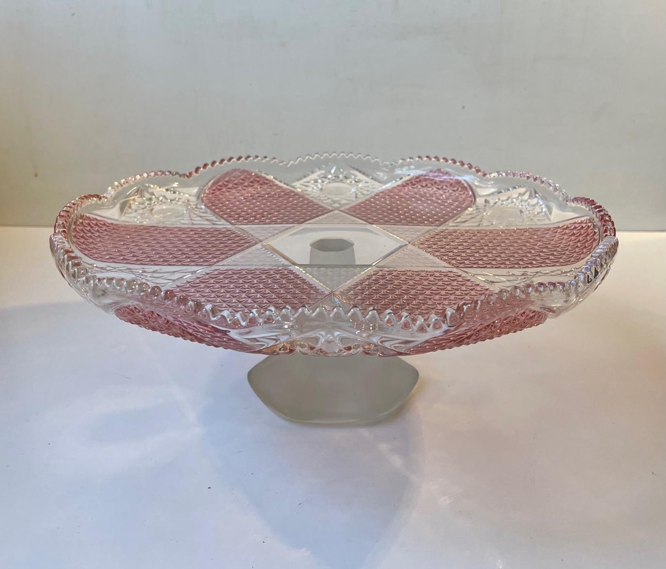 A large high quality crystal and glass cake stand. Heavy enough to support even the most intensely decorated cakes. Its foot is made from frosted solid glass. Feminin midcentury styling. Made in Bohemia/Czech Republic during the 1960s or 1970s.