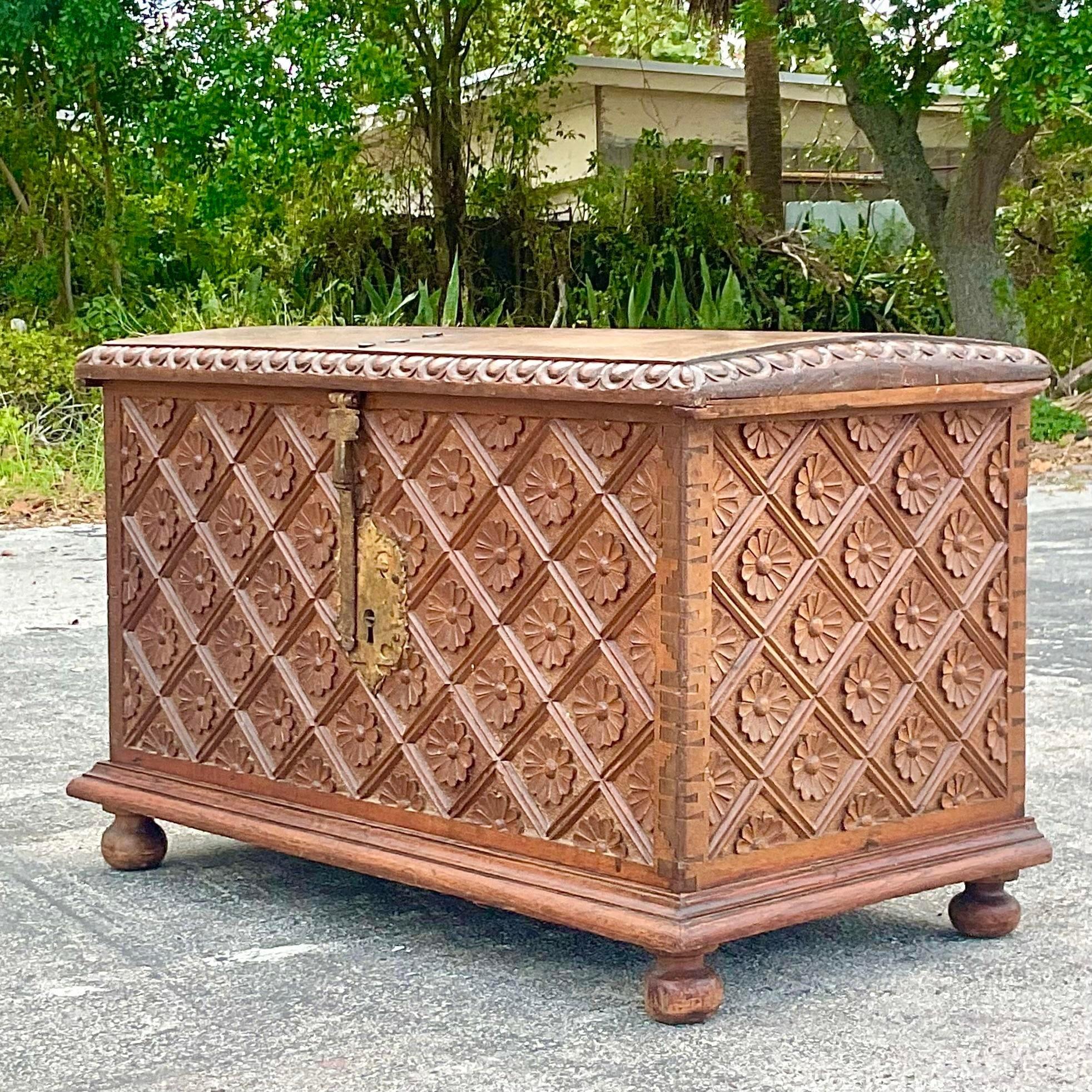 A fabulous vintage Boho wooden trunk. An 18th century hand carved chest with emblematic Spanish icons. Impressive hand forged hardware. Dimes top and notched frame. Acquired from a Palm Beach collector.