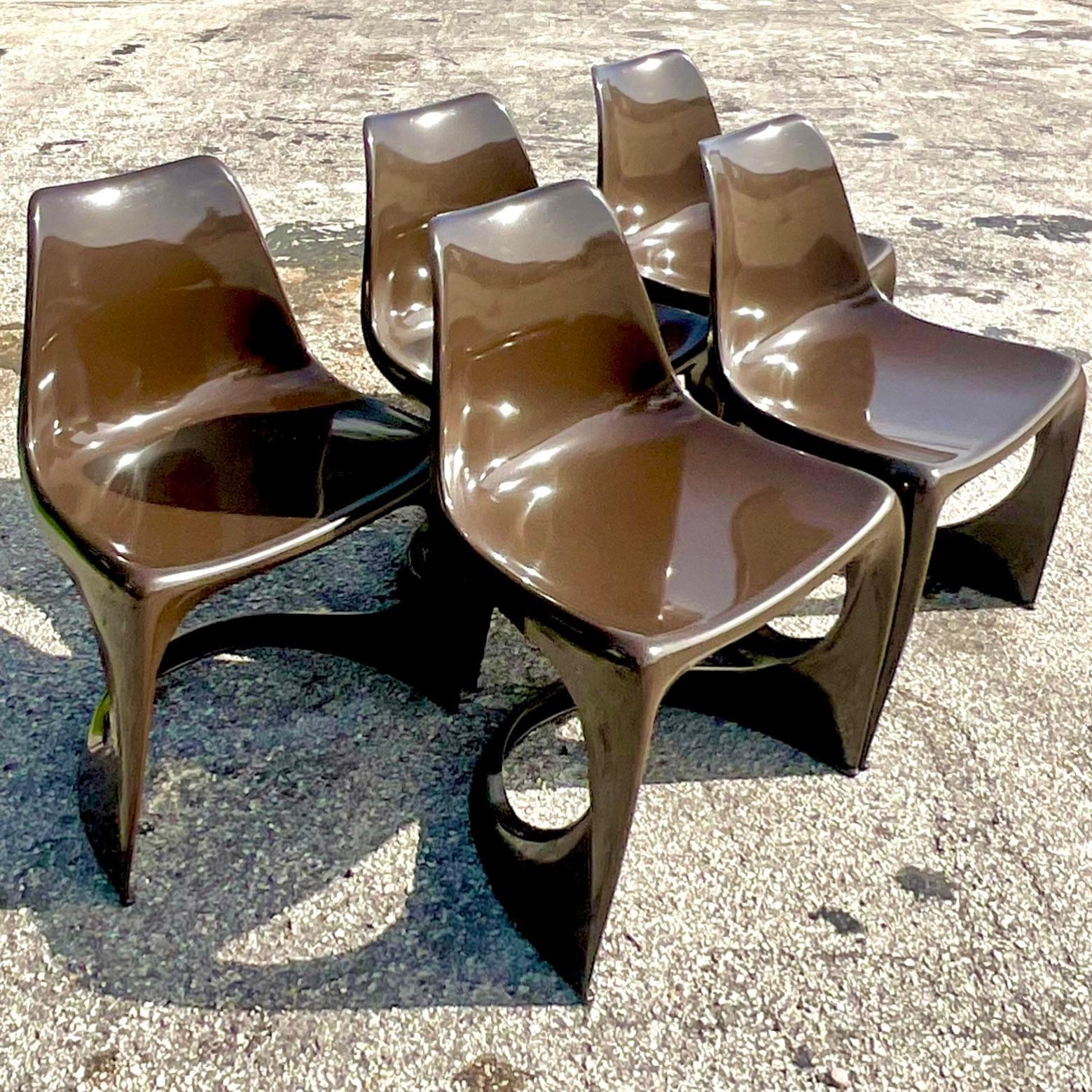 A fabulous set of 5 vintage Boho dining chairs. Designed by Steen Ostergaard for Cado. A chic chocolate brown and tagged underneath. Acquired from a Palm Beach estate.