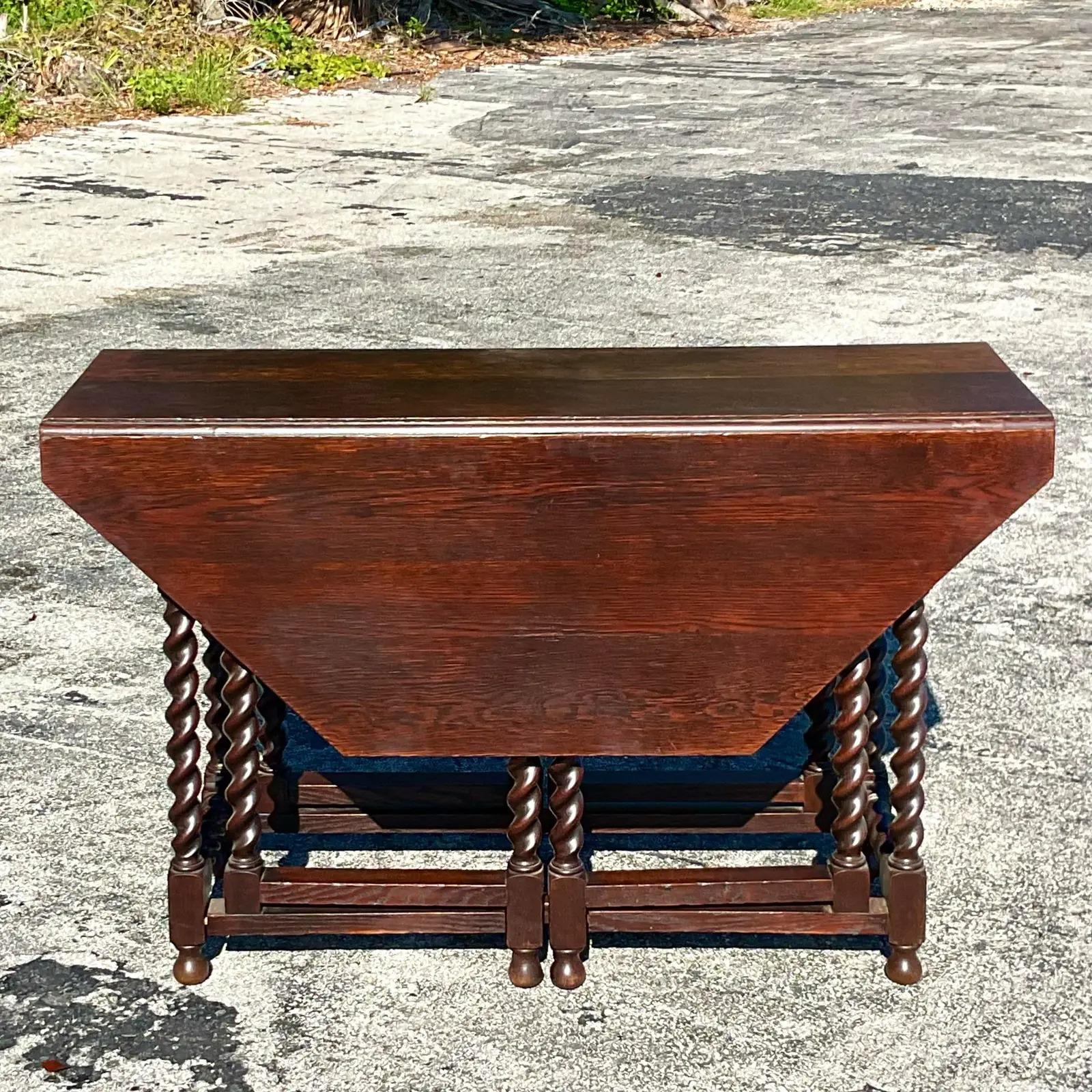 A fantastic vintage Boho 19th Century gate leg table. Beautiful as a console table, but then easily converted to a game or dining table. You decide! Beautiful Barley Twist design with a chic octagon tabletop. Acquired from a Palm Beach estate.