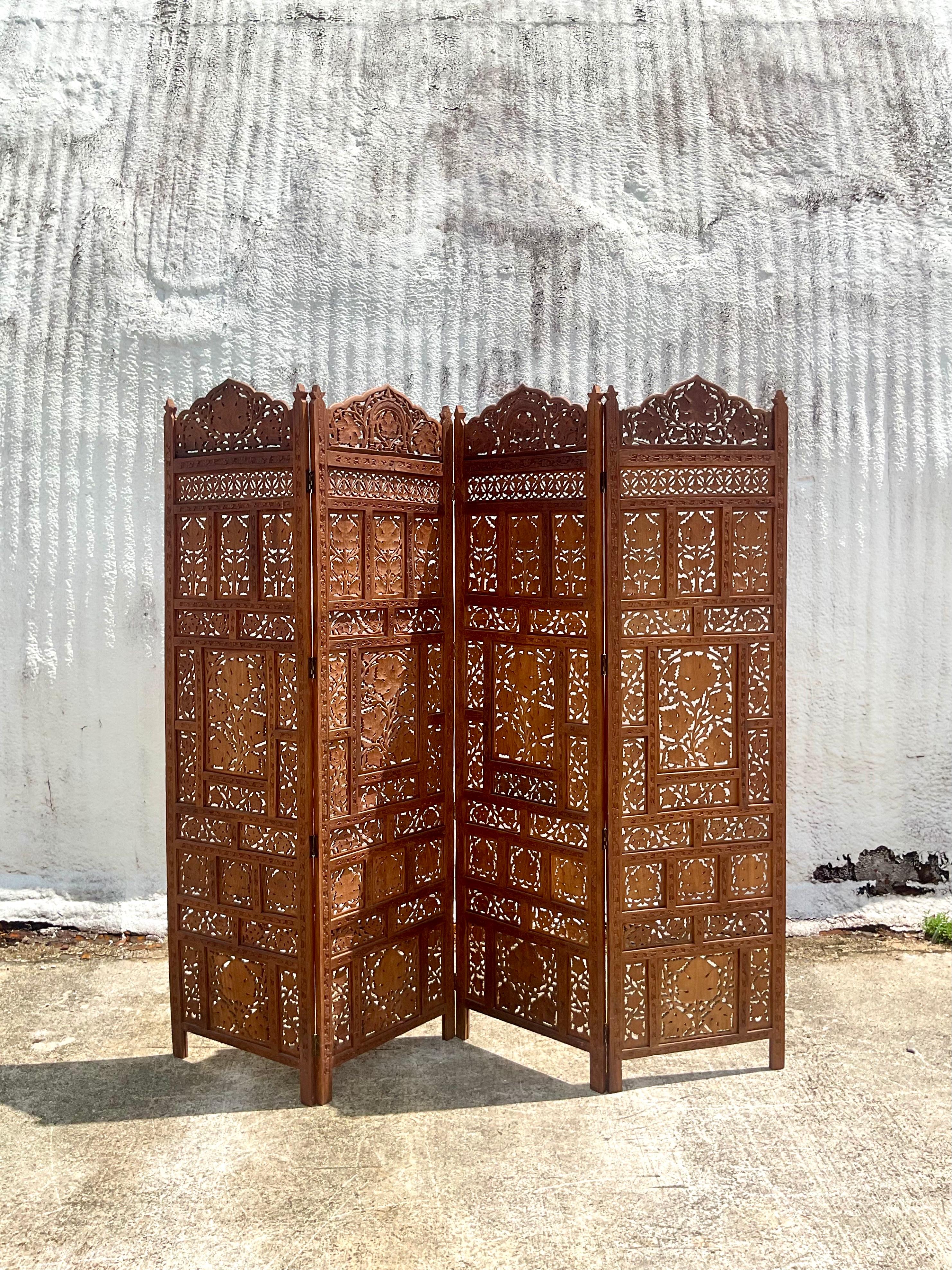 Fabulous vintage hand carved vintage folding screen. The iconic “Angure Ka Parre” design to commemorate the grape harvest. Acquired from a Palm Beach estate.