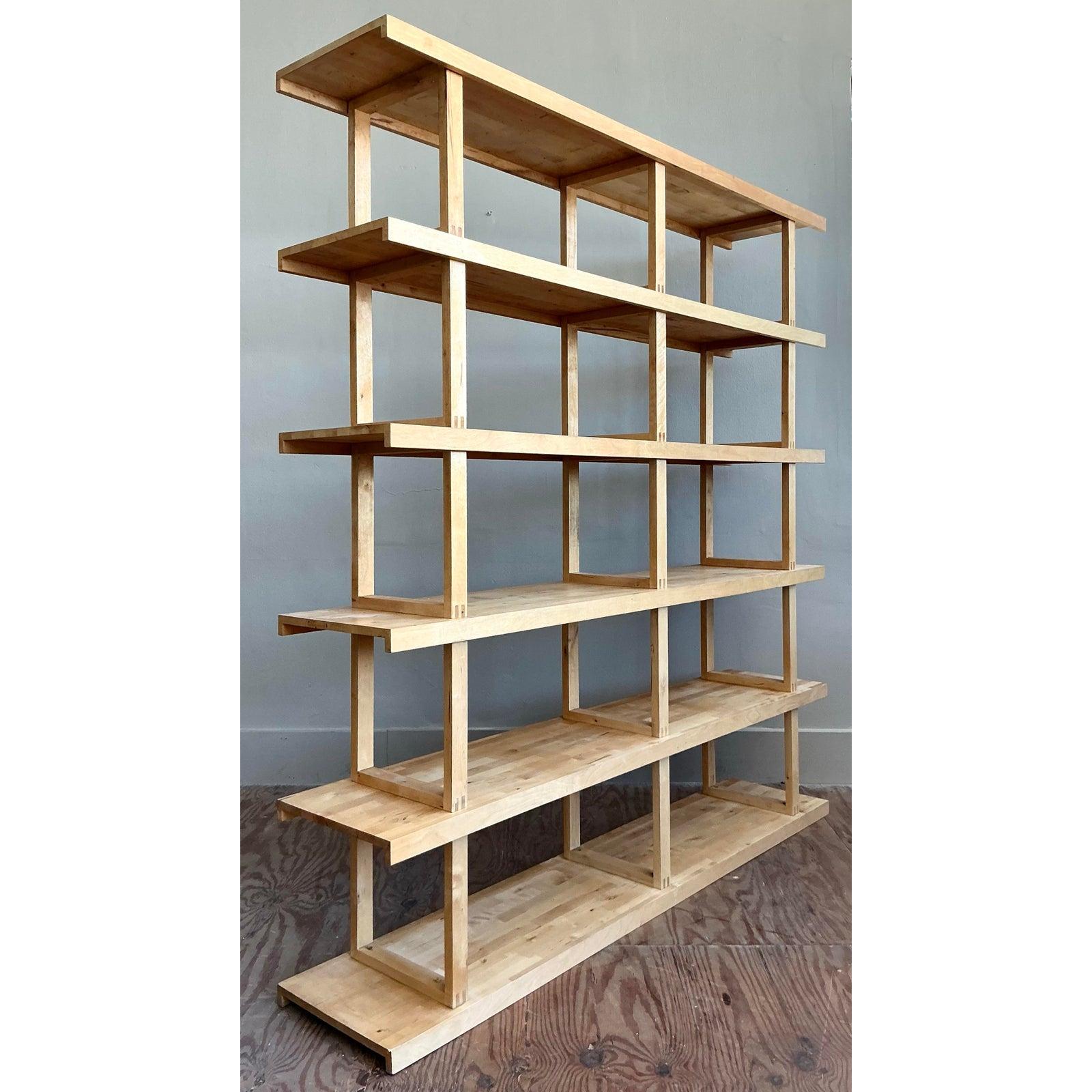 Celebrate the beauty of form and function with this monumental architectural etagere. A striking statement in minimalist design, this piece features a clean, grid-like structure crafted from a beautiful light wood, possibly maple. The exceptional