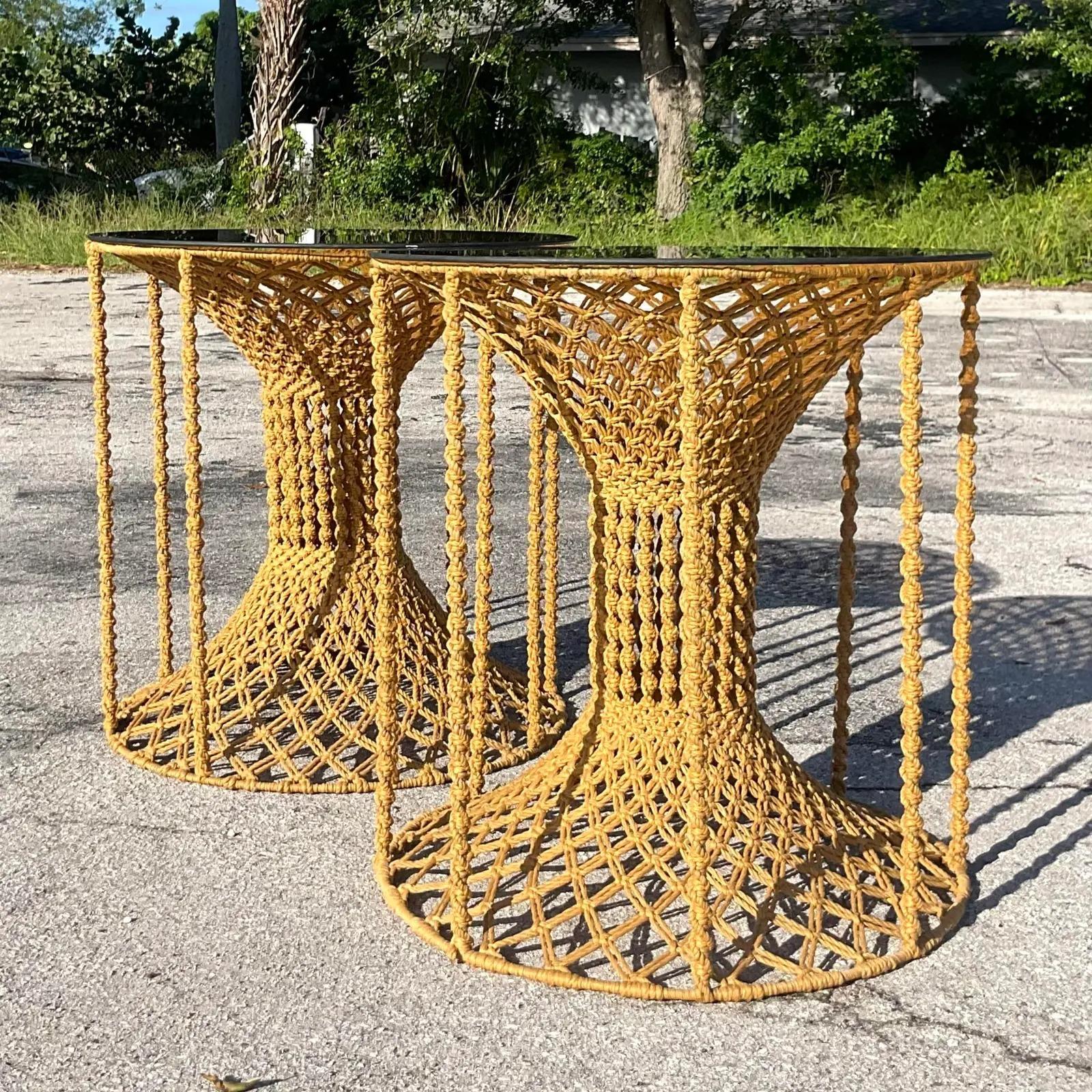 An amazing pair of vintage Boho Side tables. Beautiful hand made macrame construction with smoked glass tops. Acquired from a Palm Beach estate.