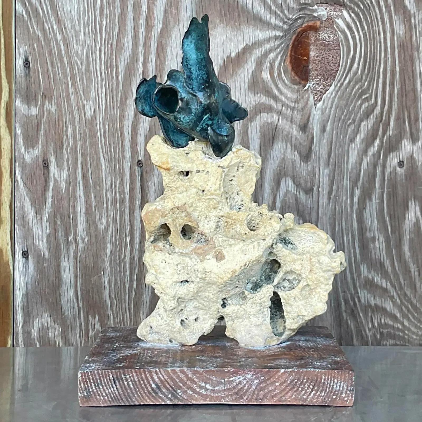 An exceptional vintage Coastal sculpture. A chic Abstract composition with a little biomorphic bronze shape embedded into a coquina rock. Rests on a cerused wood plinth. Acquired from a Palm Beach estate.