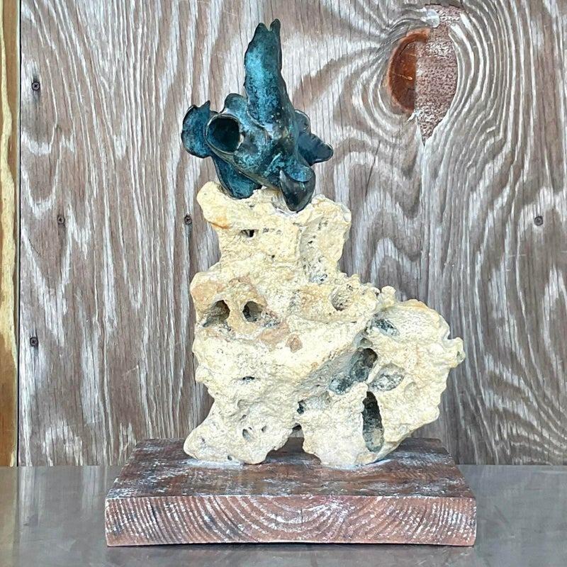 An exceptional vintage Coastal sculpture. A chic Abstract composition with a little biomorphic bronze shape embedded into a coquina rock. Rests on a cerused wood plinth. Acquired from a Palm Beach estate.
