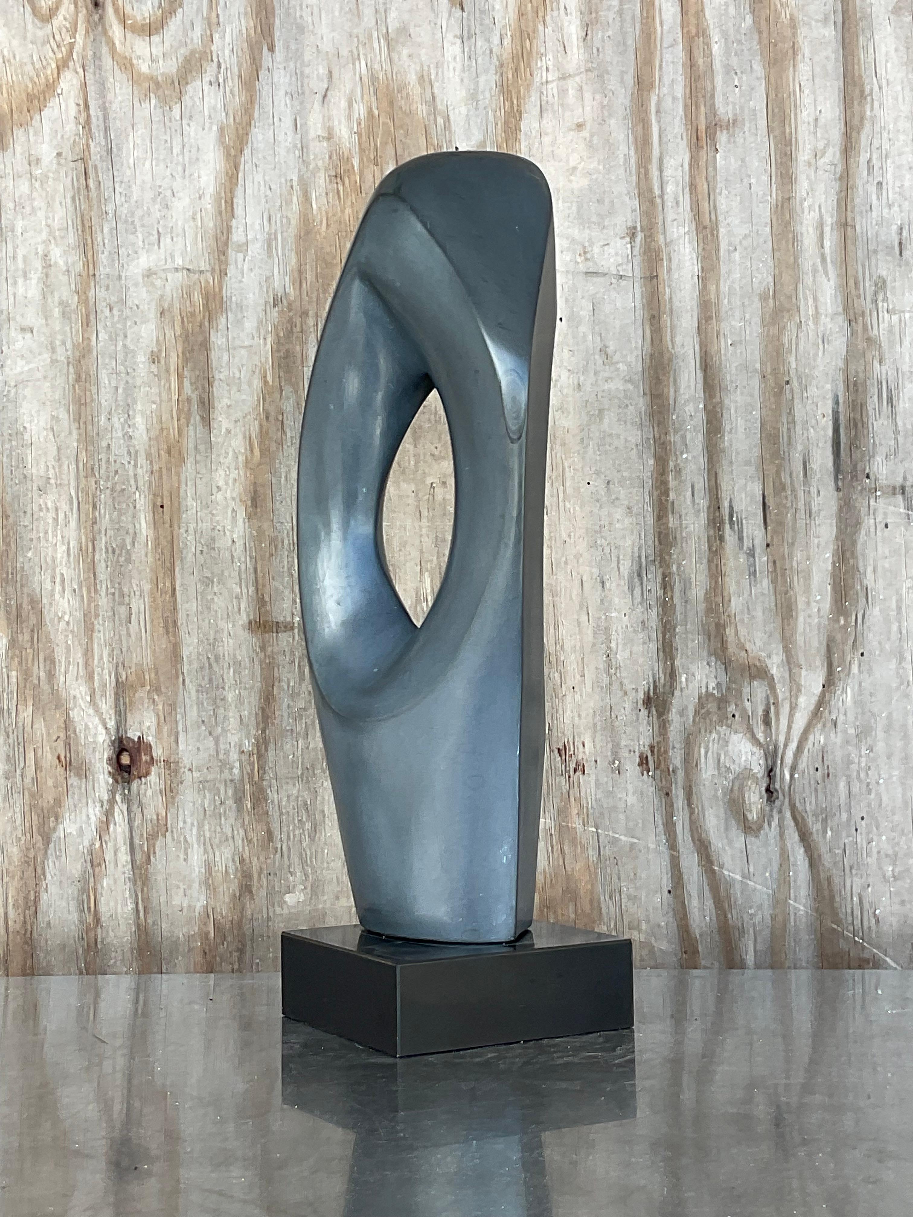 A fabulous vintage abstract sculpture. A beautiful organic shape in a dark charcoal grey. Unsigned. Acquired from a Palm Beach estate.
