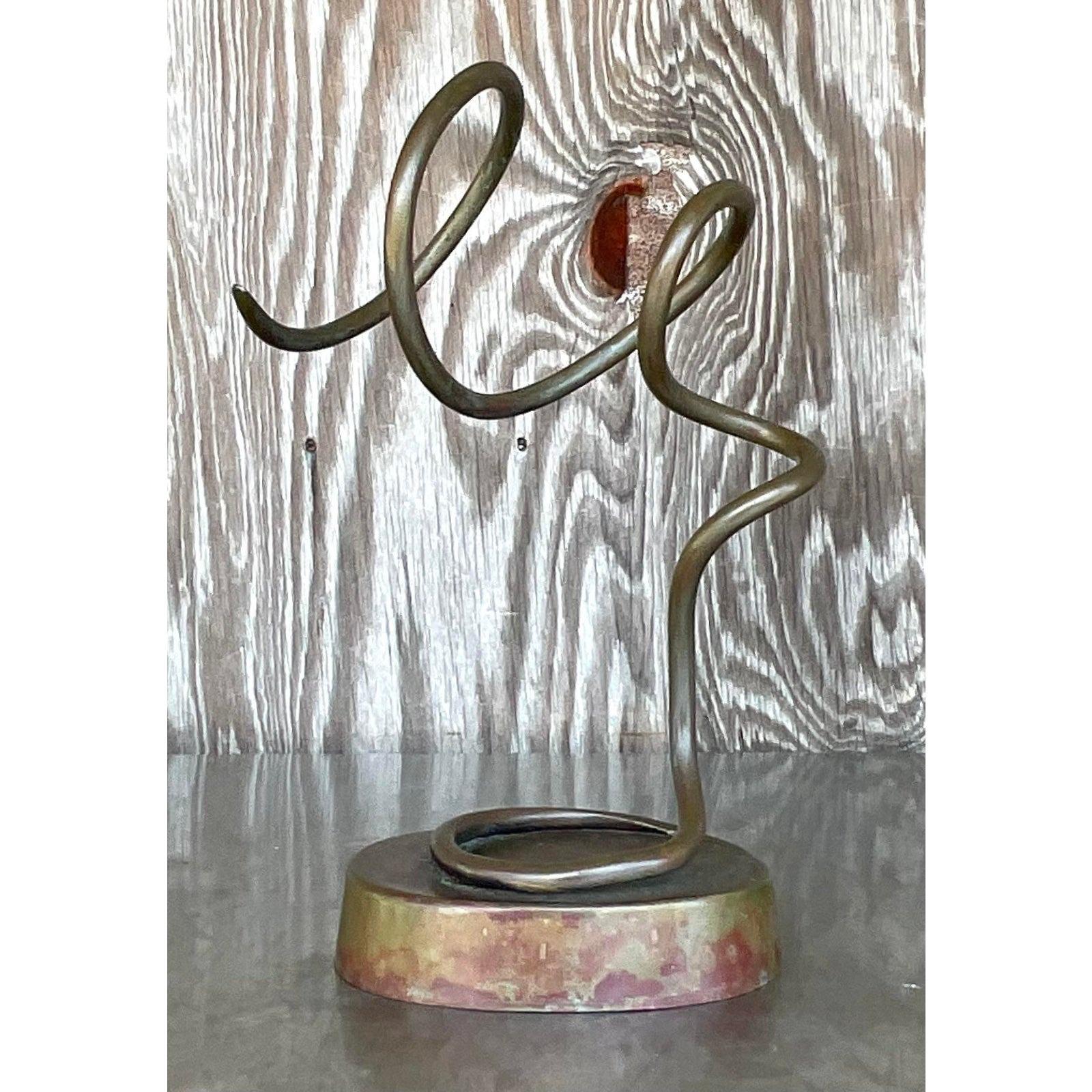 A fabulous vintage Boho metal sculpture. A chic patinated finish on a swirl design. Acquired from a Palm Beach estate.

The sculpture is in great vintage condition. Minor scuffs and blemishes appropriate to its age and use. All over patinated finish