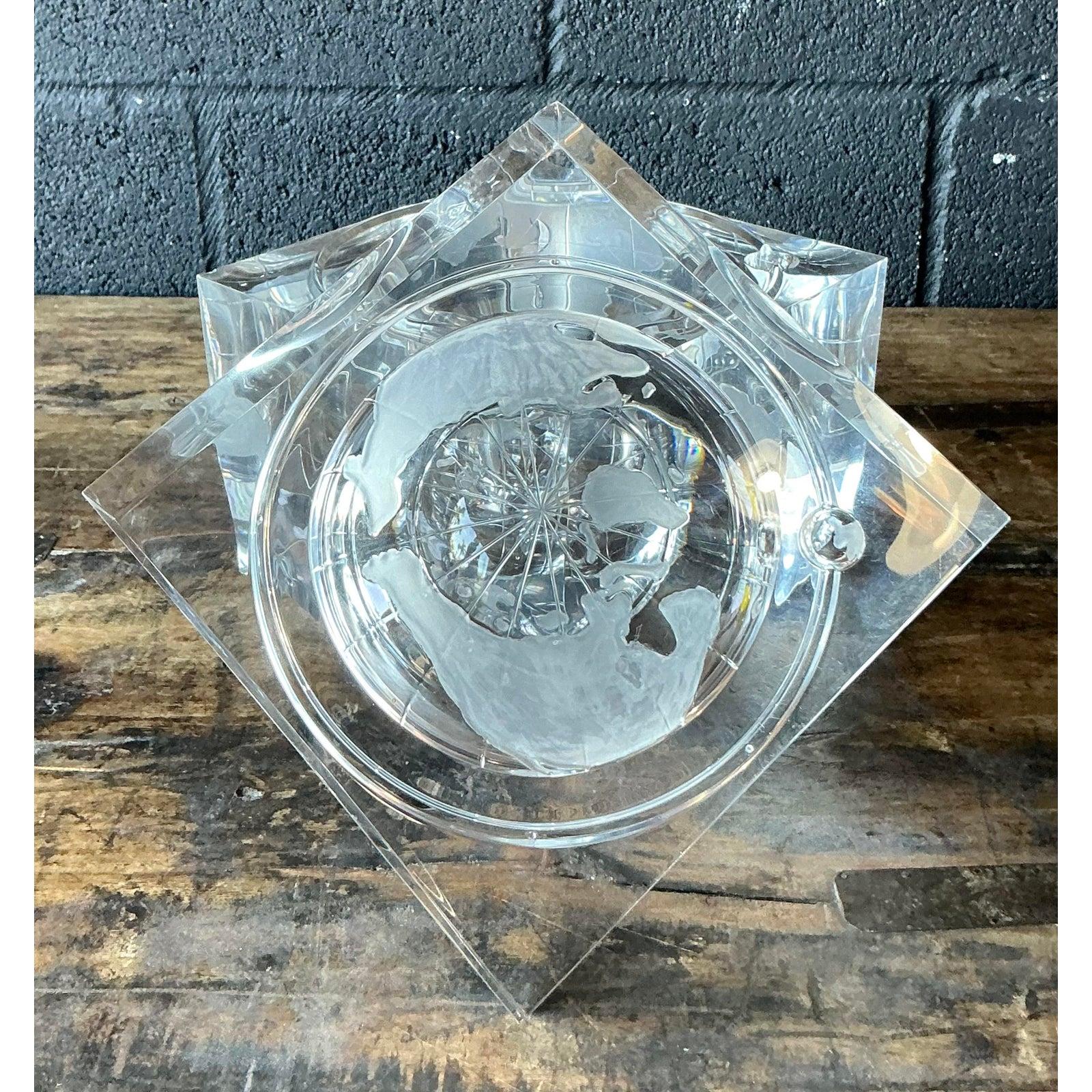This substantial vintage acrylic or Lucite cube serves as a fascinating example of Mid-Century Postmodern design, utilizing clear material for optical effects. The heavy, polished cube features a cylindrical interior cavity that houses an