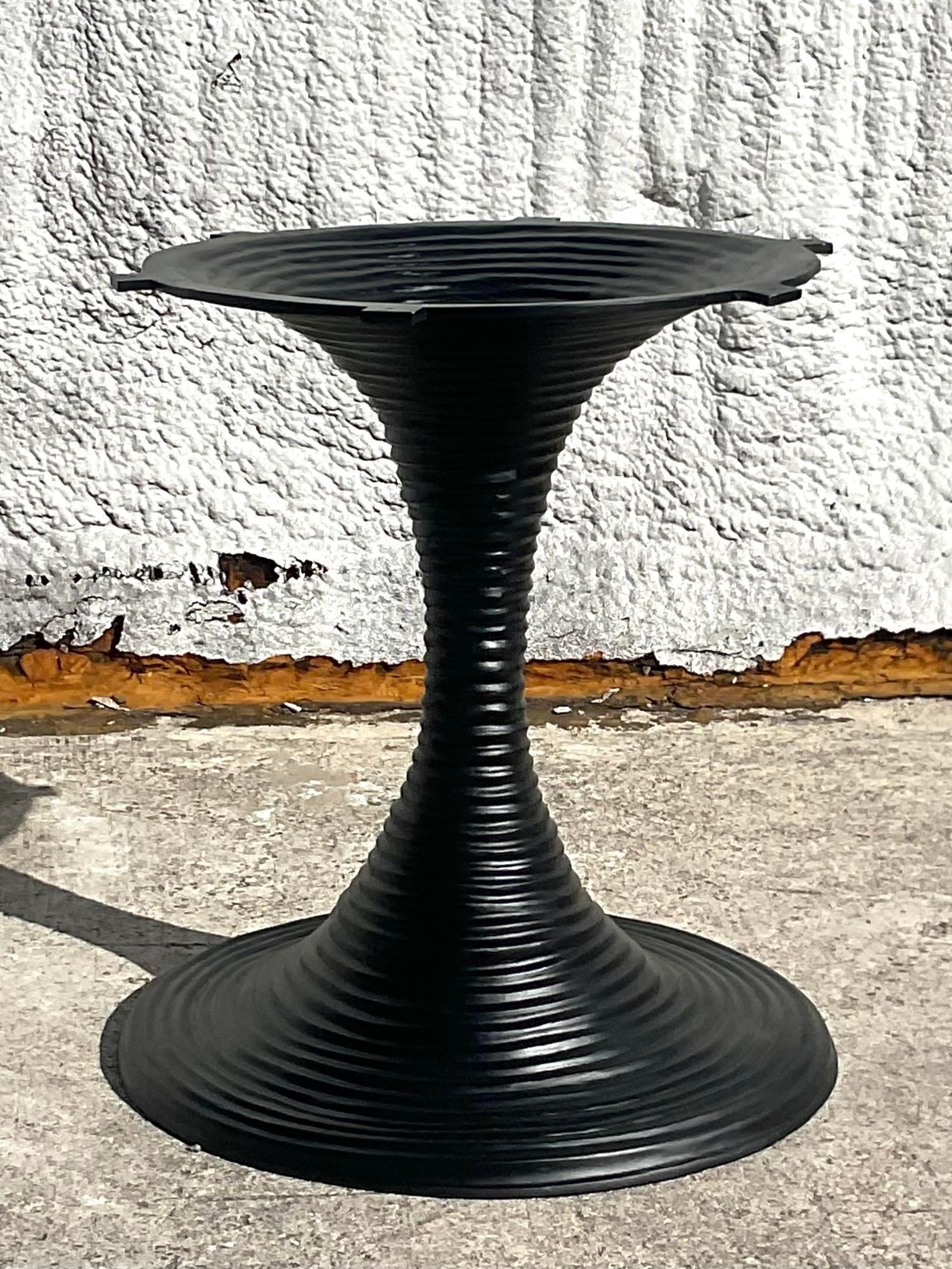 A striking vintage Boho dining table. Made by the iconic Alfonso Marina group and signed on the bottom. A striking stacked metal tulip pedestal with a bull nose stone top. Acquired from a Palm Beach estate.