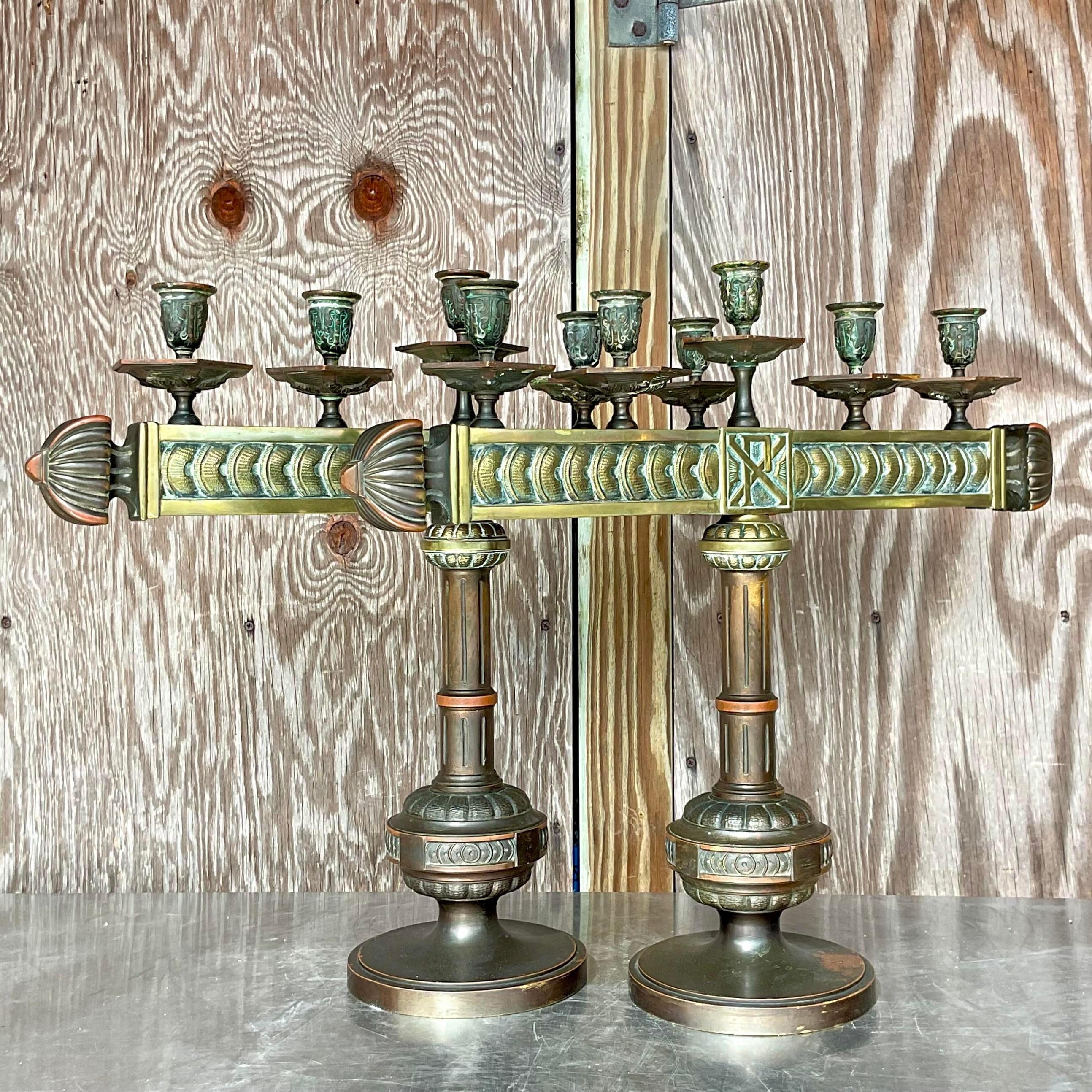 A fantastic pair of vintage Boho candelabras. Incredible rich detail on these heavy bronze masterpieces. Sure to add a flash of chicness to any space. Acquired from a Palm Beach estate