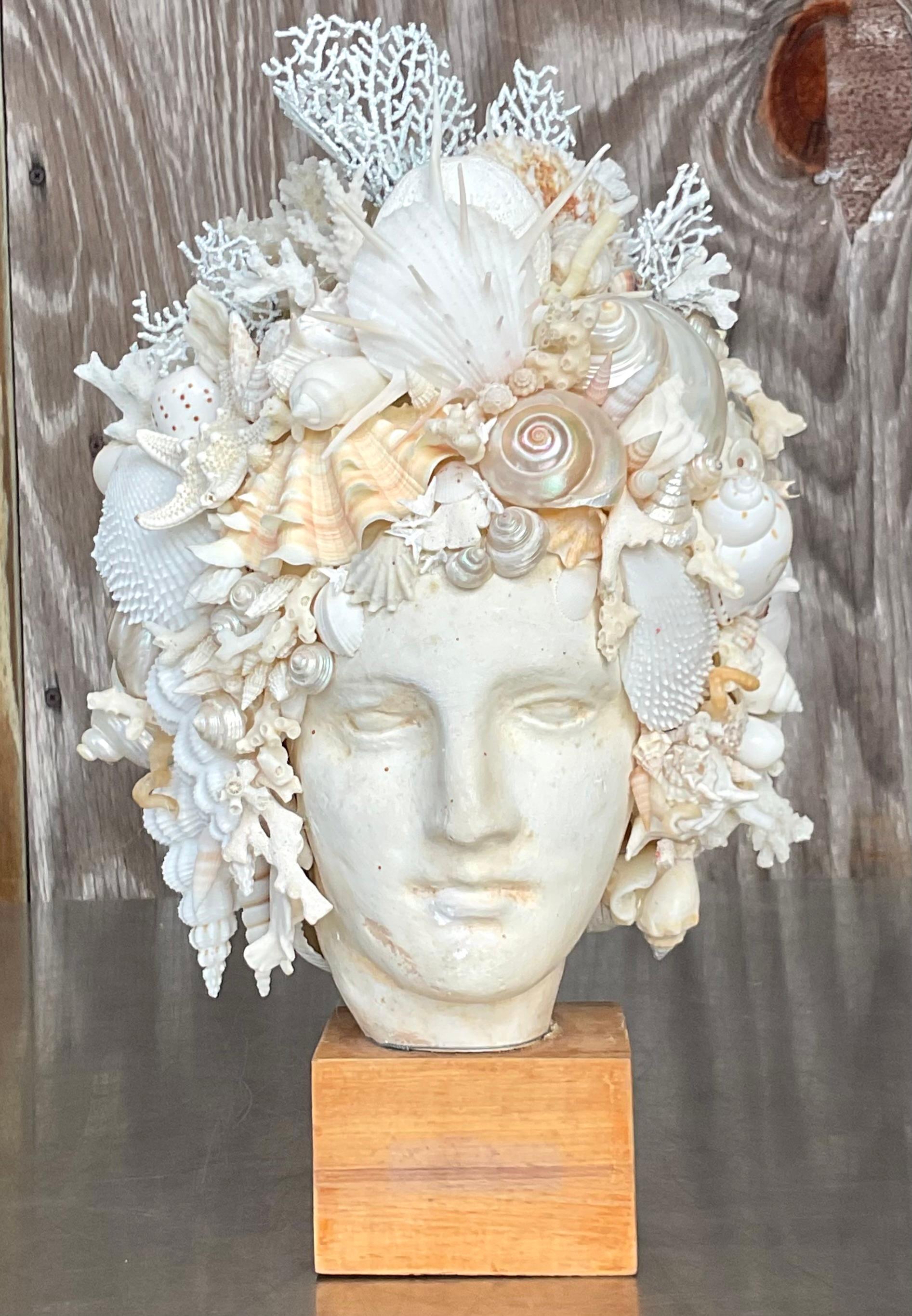A stunning vintage plaster bust. A chic Shell encrusted man with all large and interesting shells. Sure to be the focal point of any space. With a plinth for extra drama.