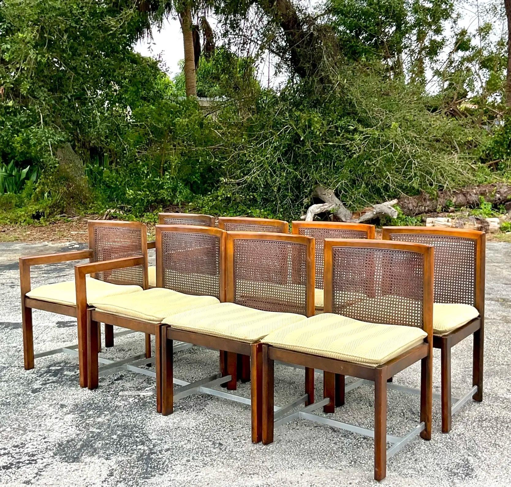 This Vintage Boho Baker Cane Dining Chairs exudes timeless elegance and a relaxed sophistication. Crafted by Baker Furniture, the chairs feature intricately woven cane backs paired with solid wood frames, highlighting expert craftsmanship and a