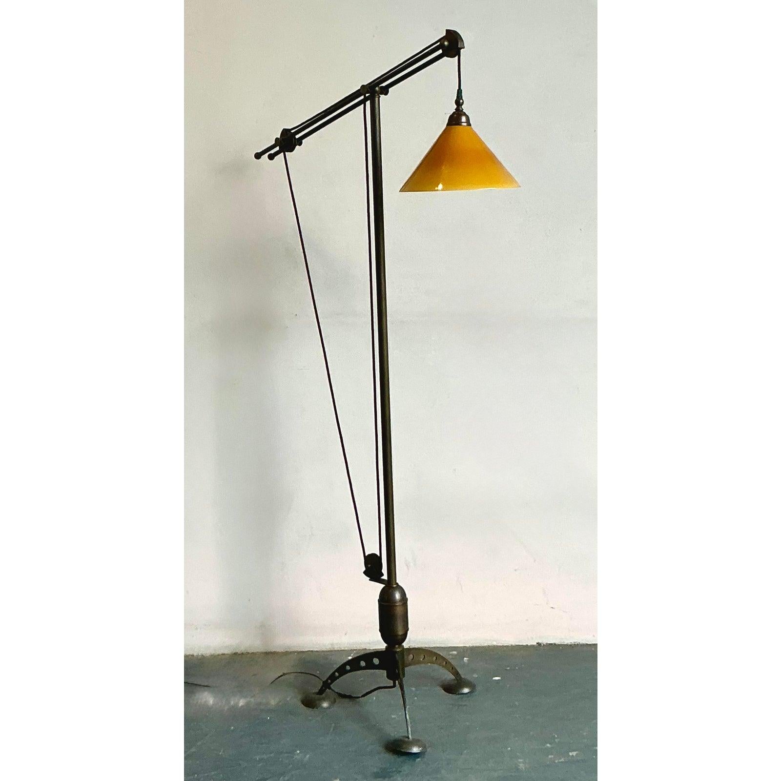 Illuminate your space with the industrial elegance of this vintage Baker MRL 191 counterbalance floor lamp. This striking piece features a robust metal frame with a fully adjustable arm and a unique pulley system, allowing you to precisely direct