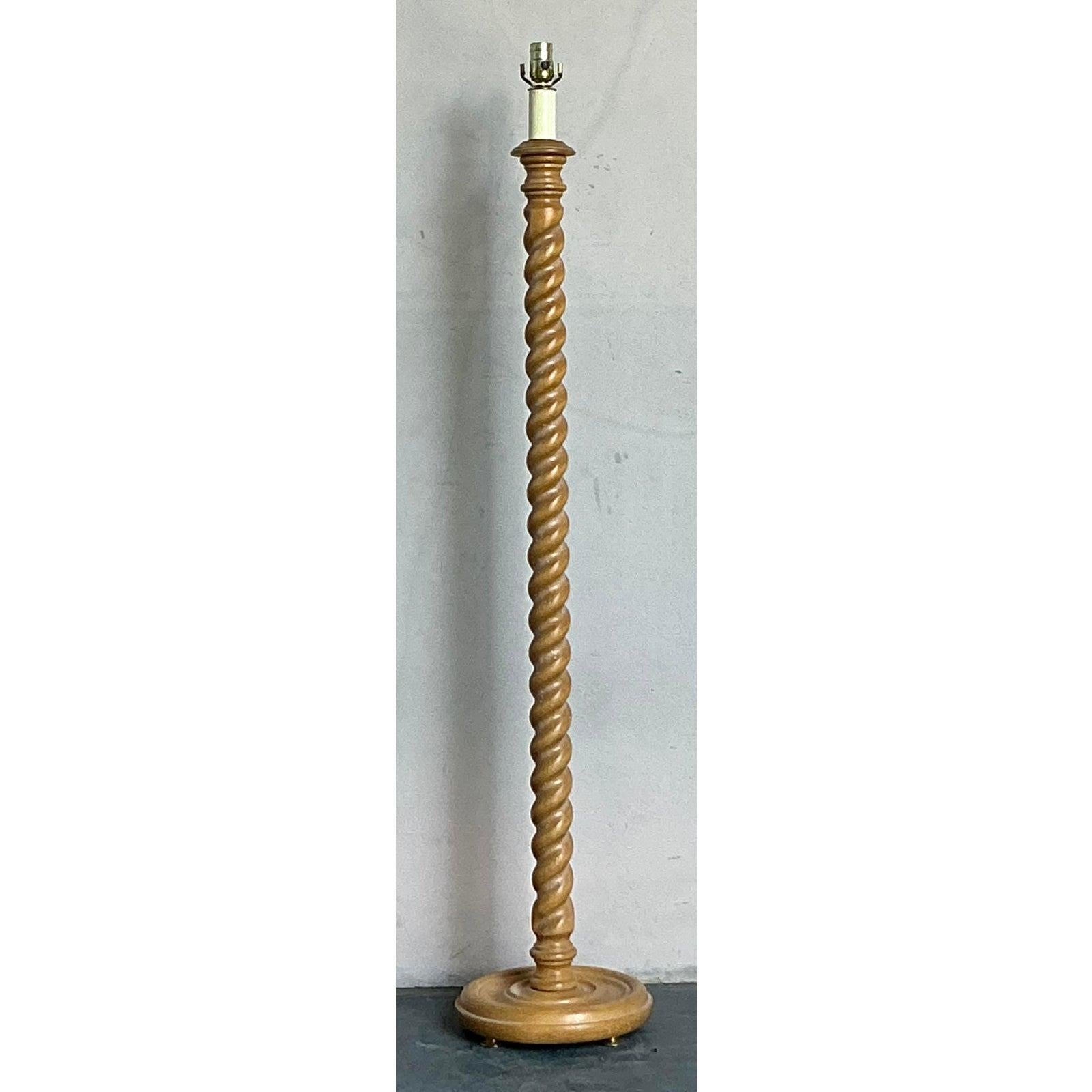 This elegant vintage floor lamp celebrates the enduring beauty of traditional woodworking, featuring a dramatically carved barley twist column. This classic design detail, popular in Jacobean and cottage revival styles, provides mesmerizing visual