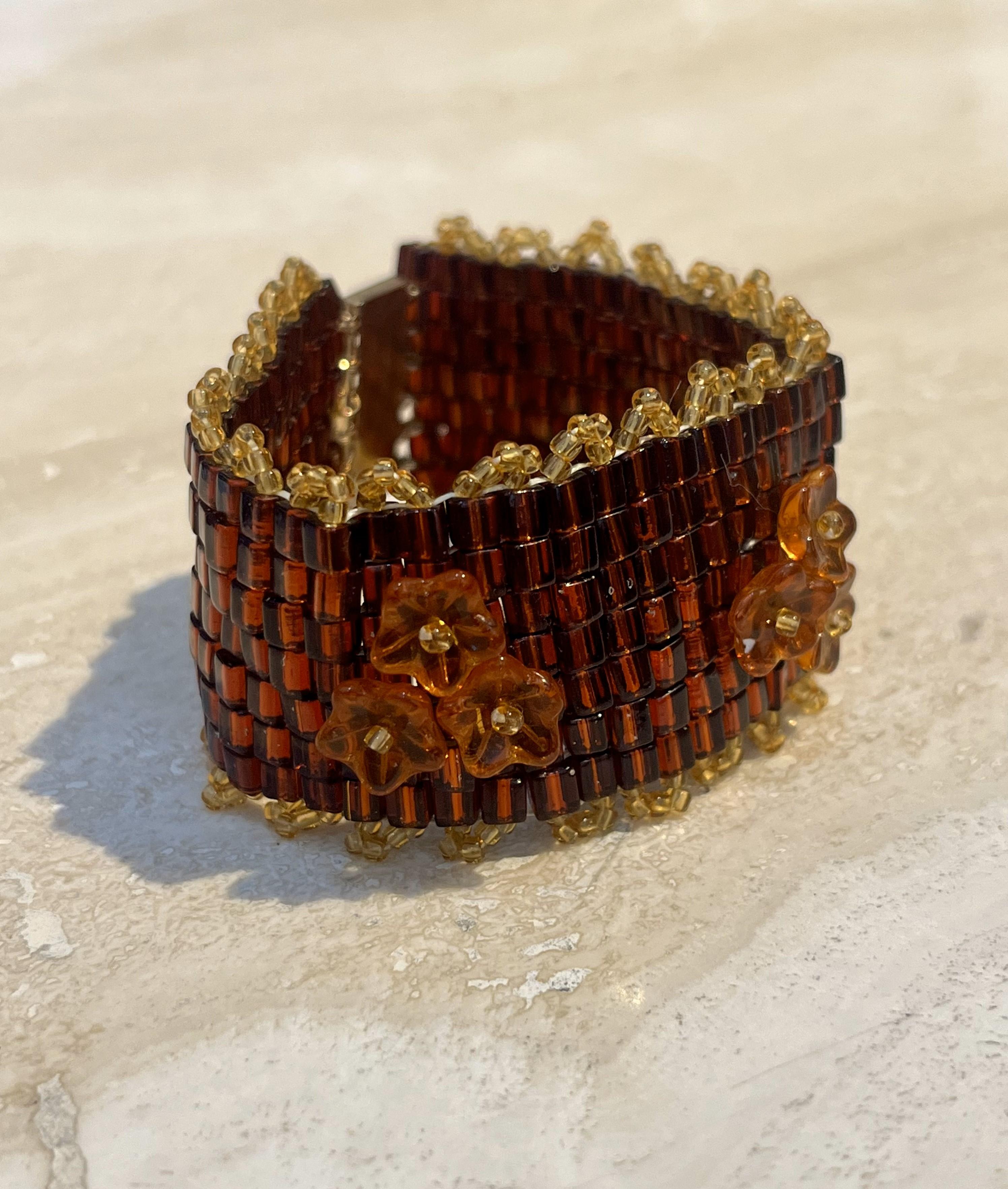 A Vintage Boho Beaded Floral Bracelet is a charming and eclectic piece that captures the free-spirited style of bohemian fashion while showcasing intricate craftsmanship and vibrant design

This bracelet is typically composed of colorful beads,
