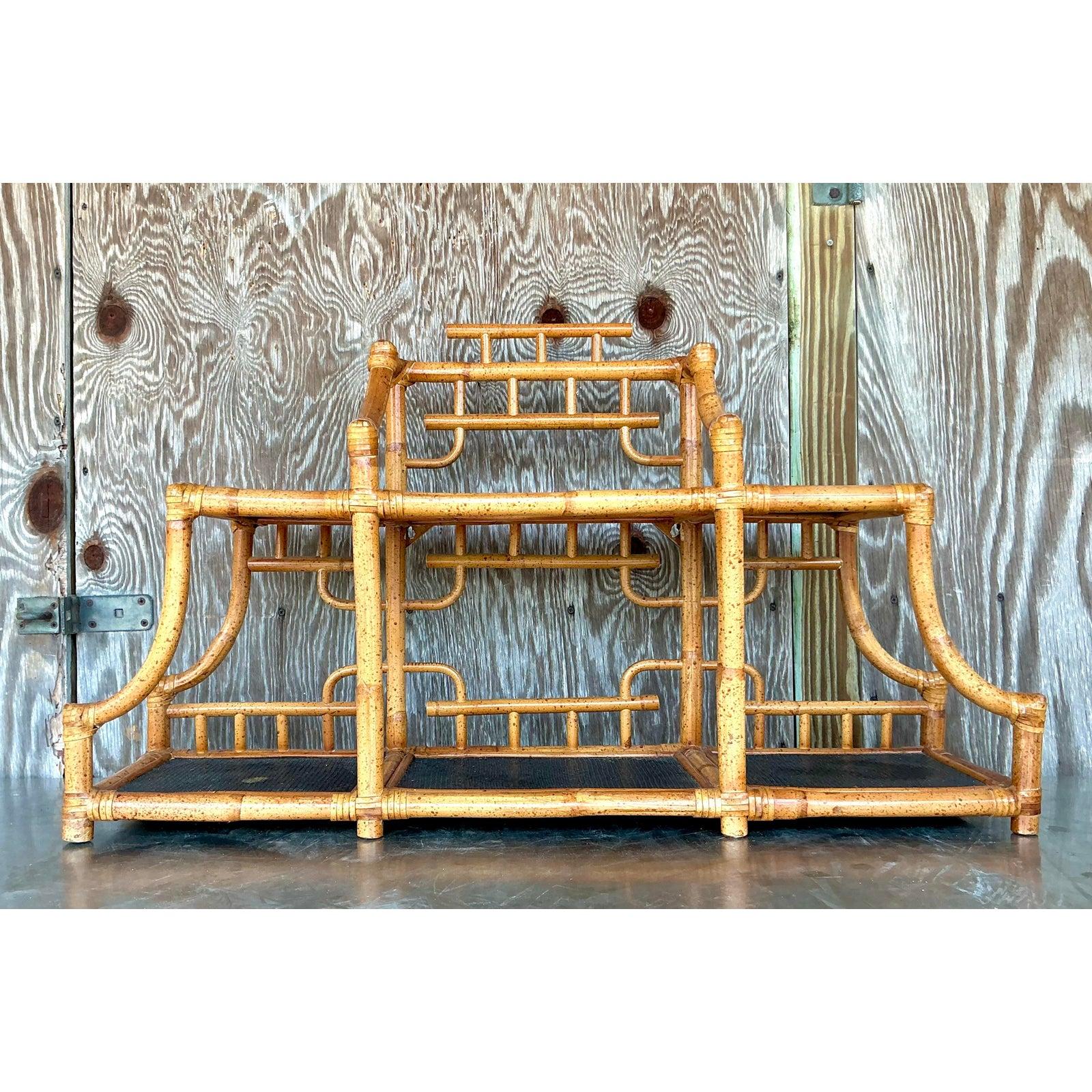 Capture the essence of worldly, layered design with this striking vintage tabletop etagere. Masterfully constructed from bent bamboo, this piece features a dramatic, architectural silhouette reminiscent of a classic pagoda. The warm, honey-toned