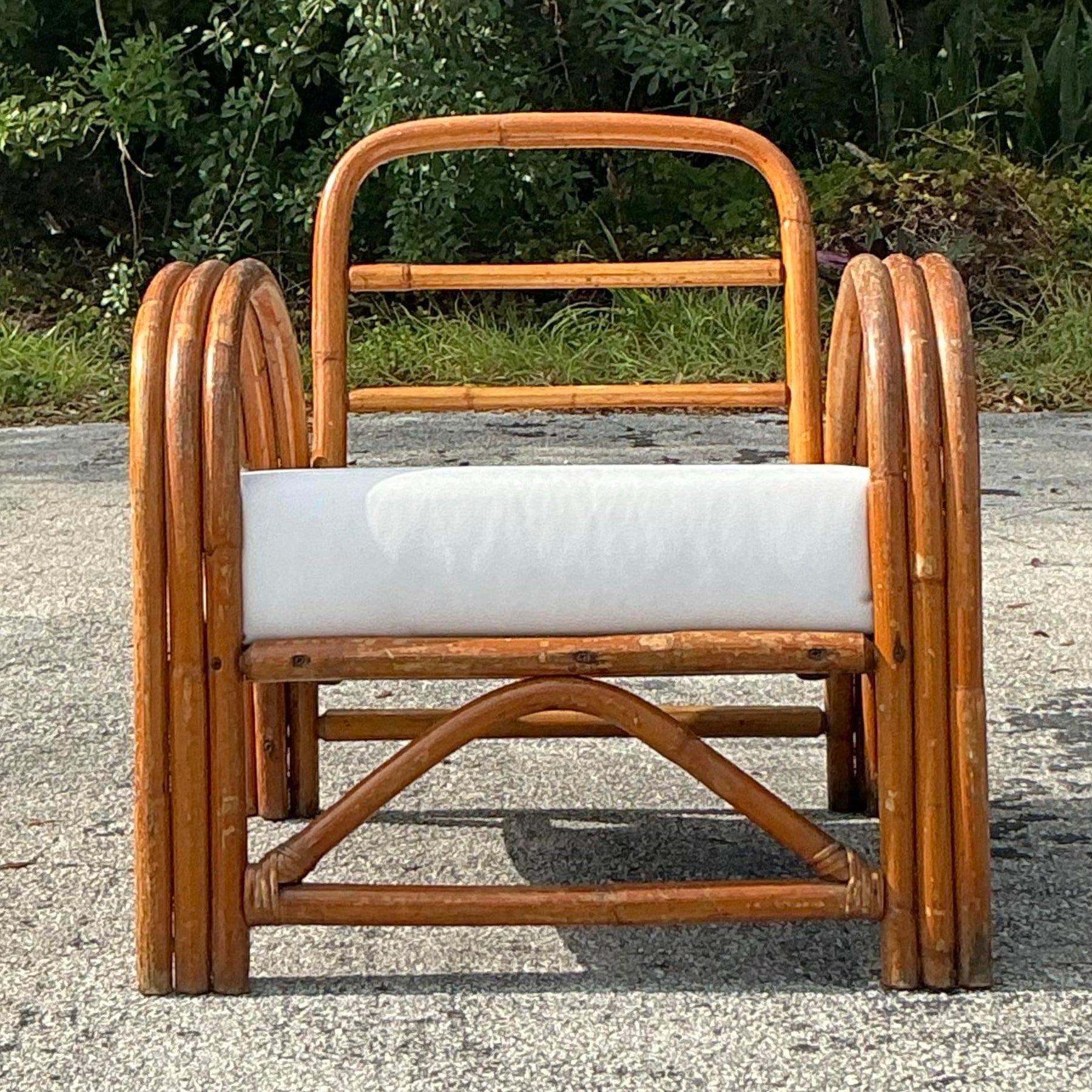 Add a touch of boho chic to your home with this vintage bent rattan lounge chair. Its gracefully curved frame and woven rattan design offer a perfect blend of comfort and natural elegance. Ideal for relaxing in a cozy corner or as a statement piece
