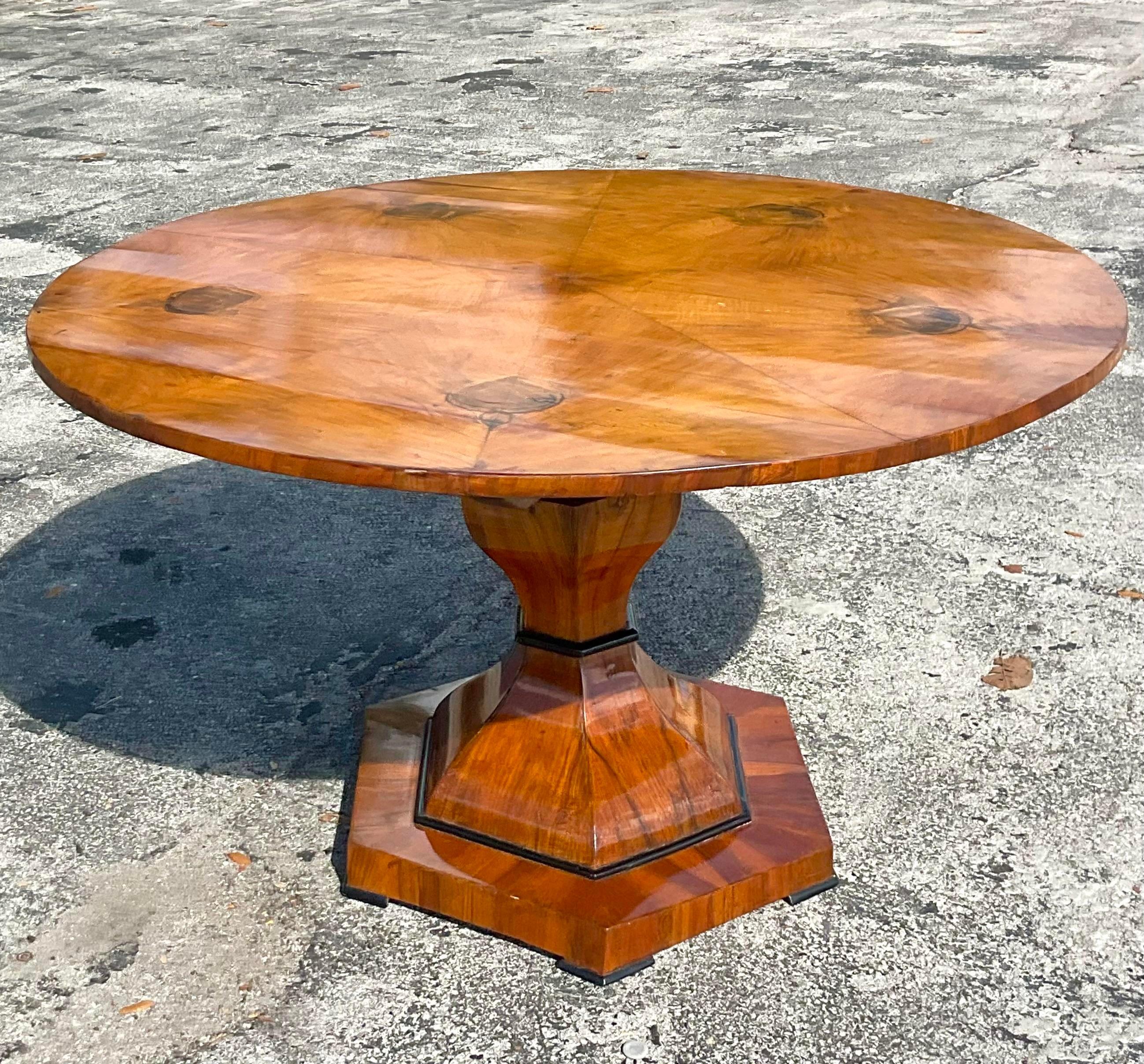 An extraordinary vintage Boho dining table. A stunning Biedermeier table with incredible wood grain detail. Original hardware with tilt top design. Acquired from a Palm Beach estate.