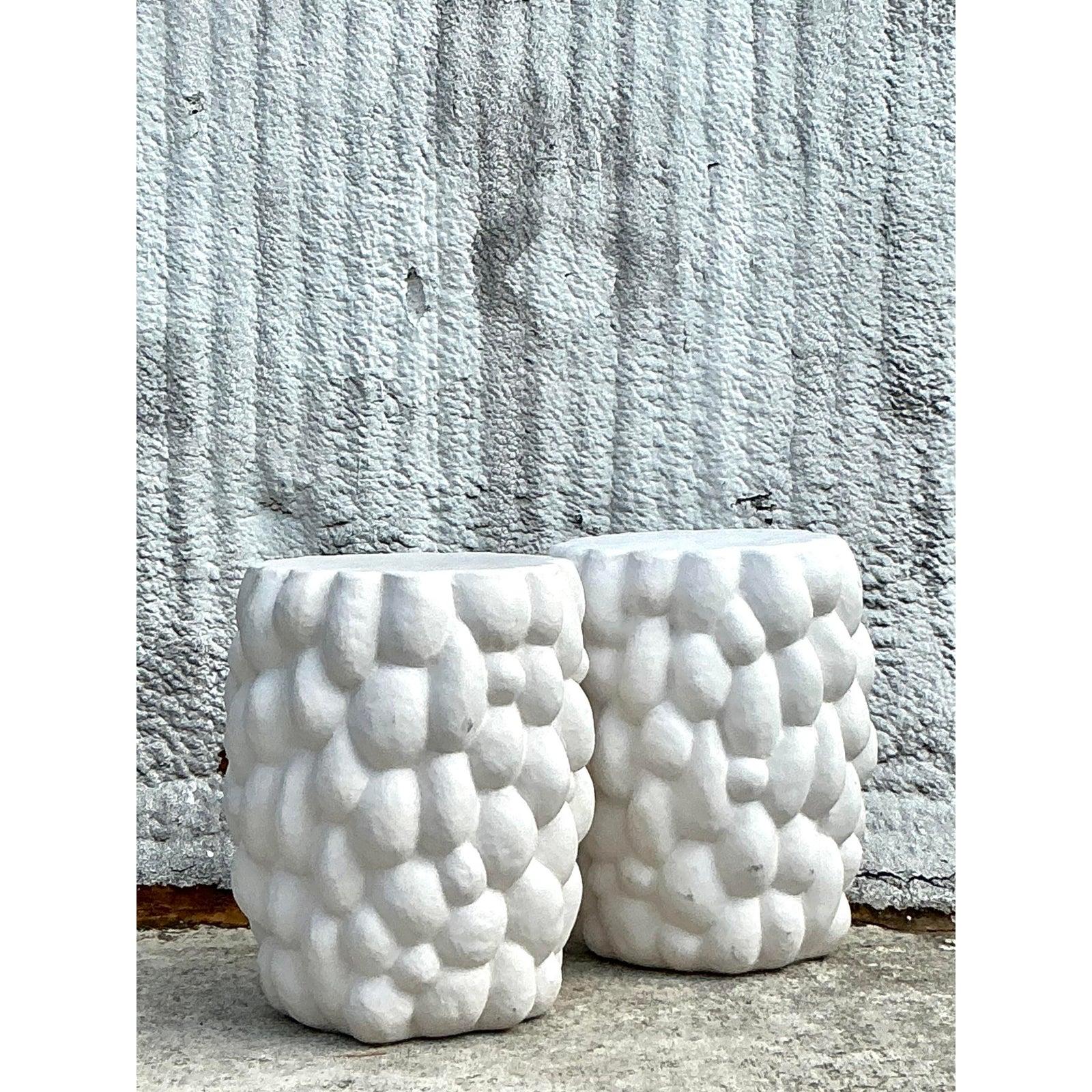 Discover the charm of these Vintage Boho Biomorphic Low Stools, a stunning pair that blends organic design with timeless craftsmanship. Their whimsical, tufted exterior, reminiscent of mid-20th-century artistry, exudes a sculptural elegance that