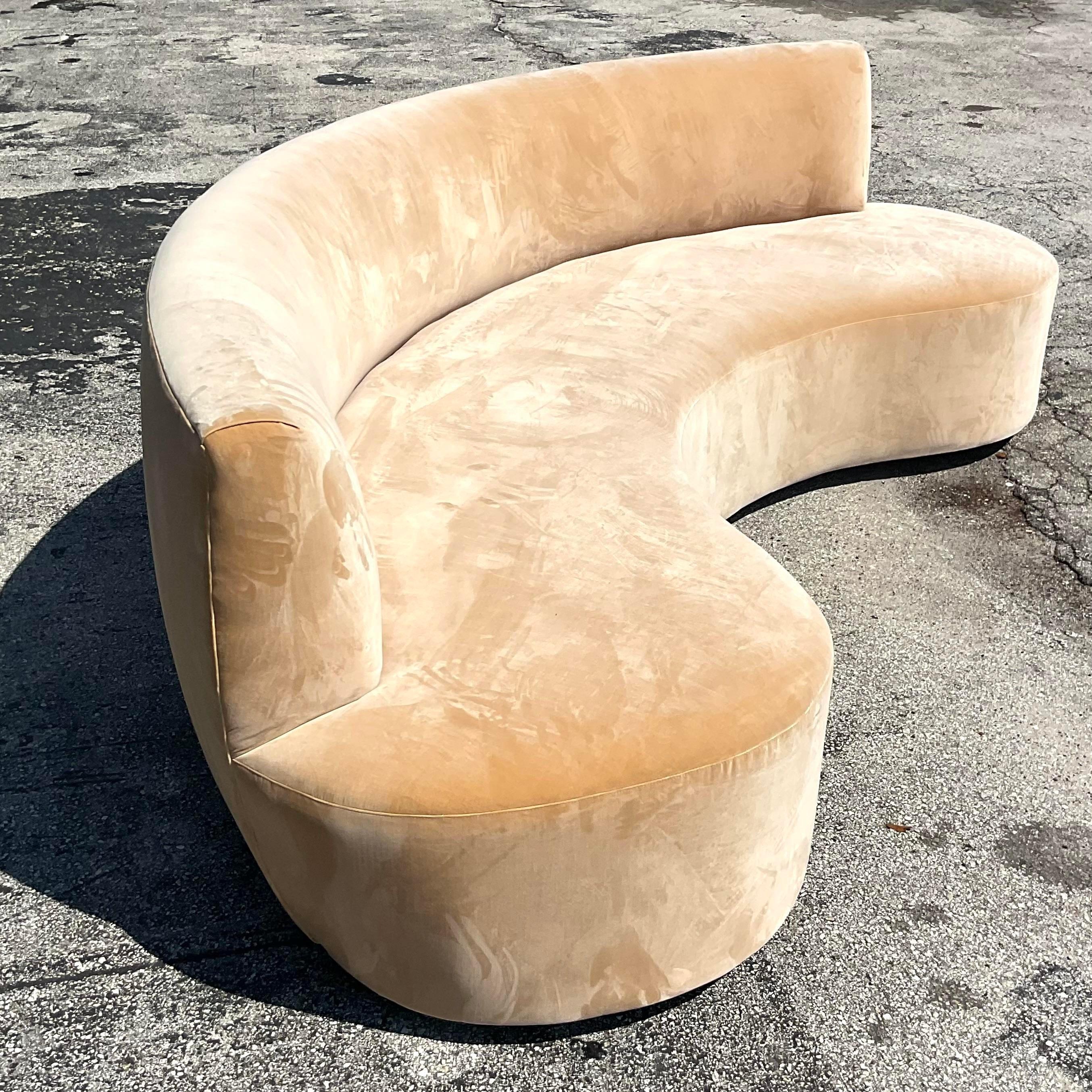 A sensational vintage Boho sofa. A chic biomorphic shape in a pale apricot velvet. Custom built and in great shape. Acquired from a Palm Beach estate.