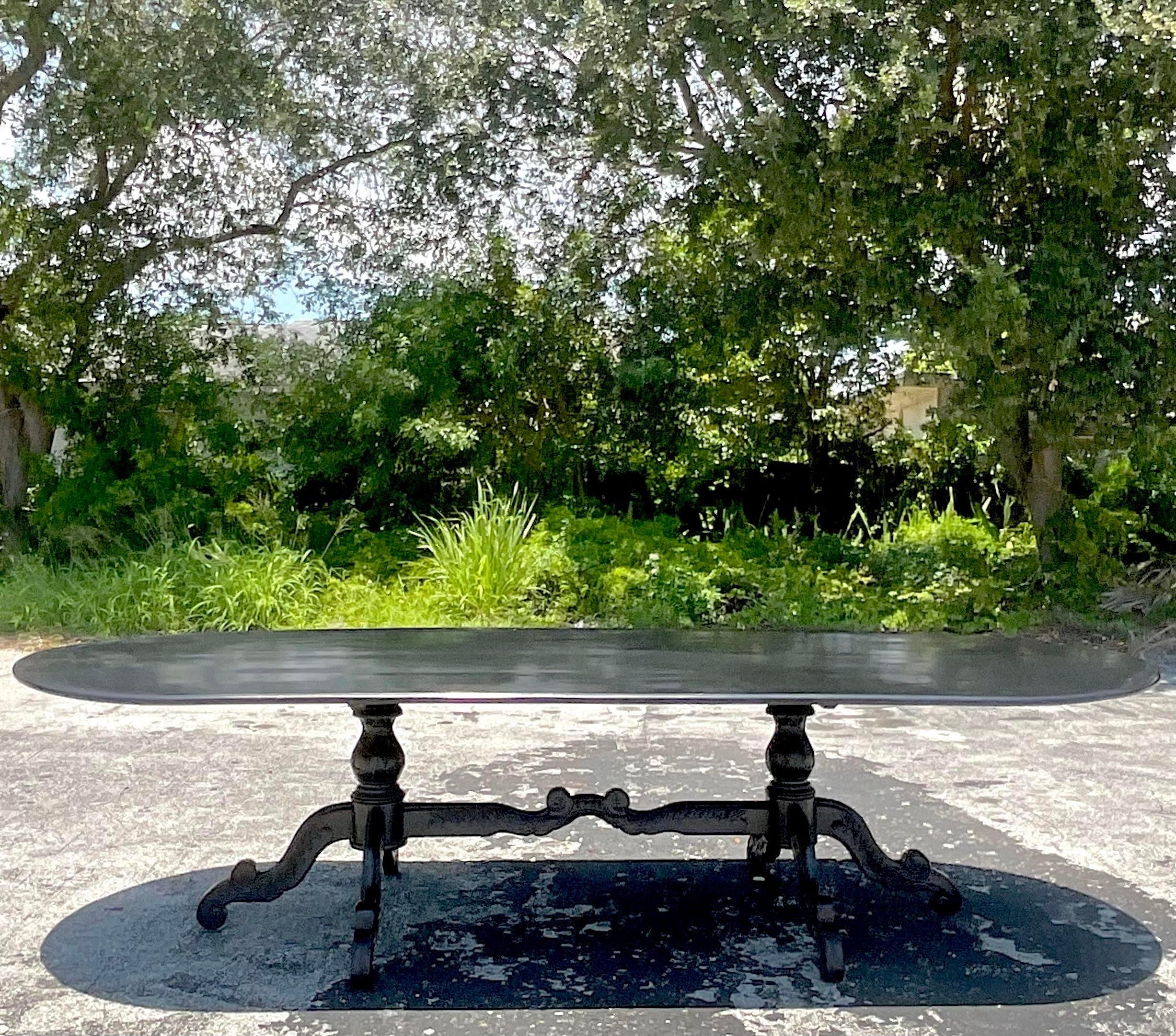 A fabulous vintage Boho dining table. A chic custom built Duncan Phyfe Style with beautiful wood carved detail. Finishes in a semi gloss black lacquer. Monumental in size and drama. Acquired from a Palm Beach estate.