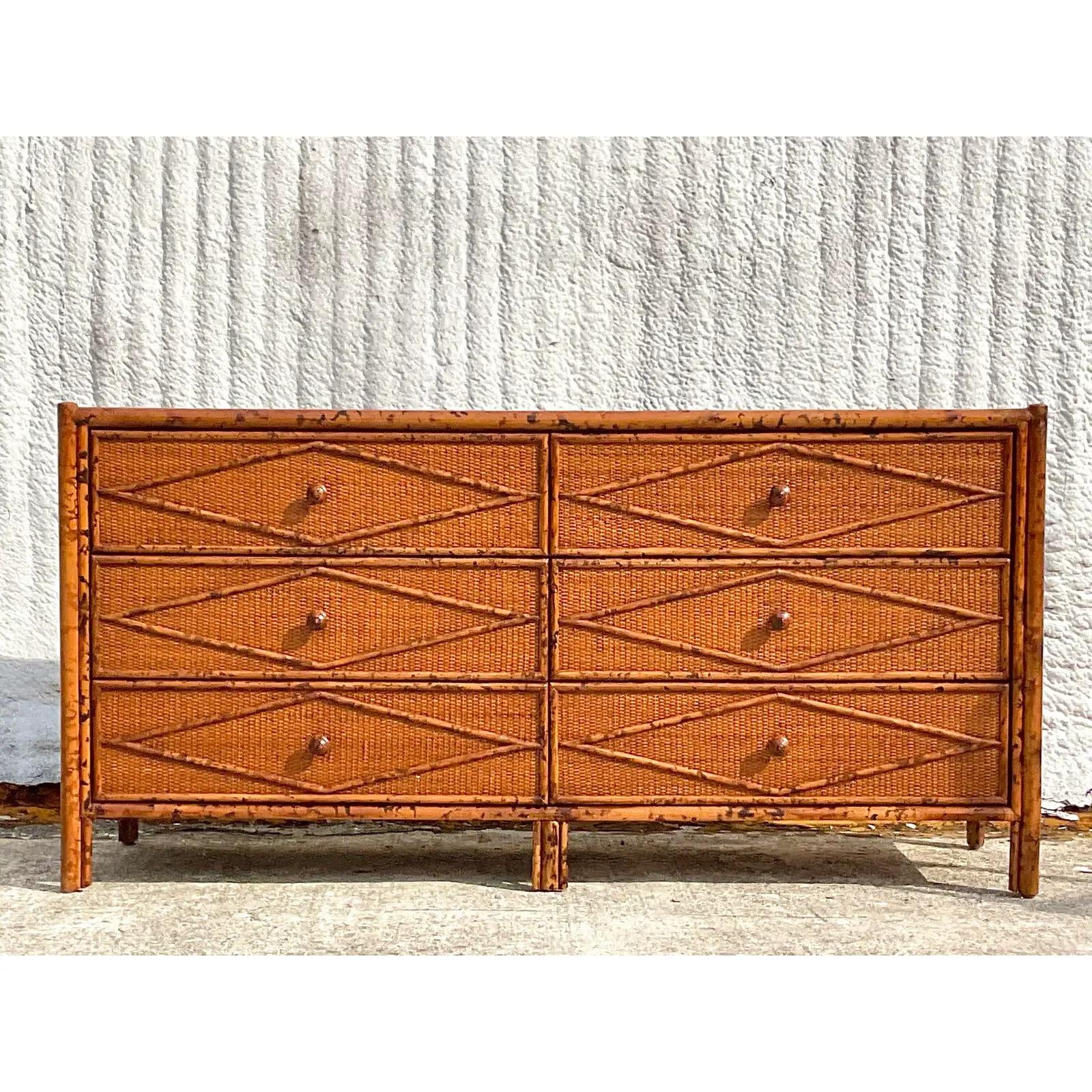A fantastic vintage Boho six drawer dresser. Beautiful tortoise bamboo with inset woven rattan panels. Made by the iconic Bloomingdale’s group. Acquired from a Palm Beach estate.
