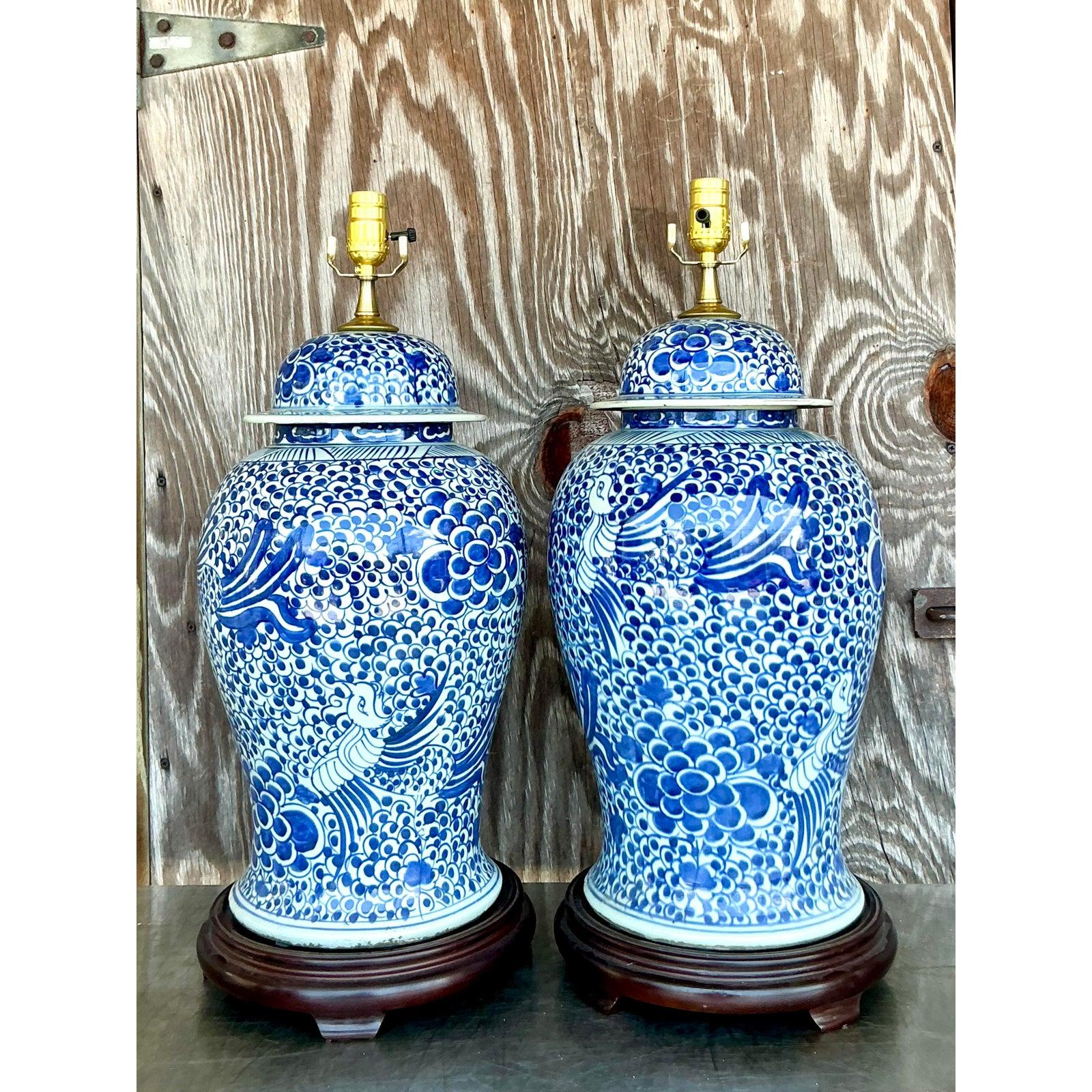 Illuminate your space with this enchanting pair of vintage boho blue and white ceramic lamps, exuding effortless charm and artisanal character. Their hand-painted motifs and crisp glaze capture the free-spirited essence of bohemian design, making