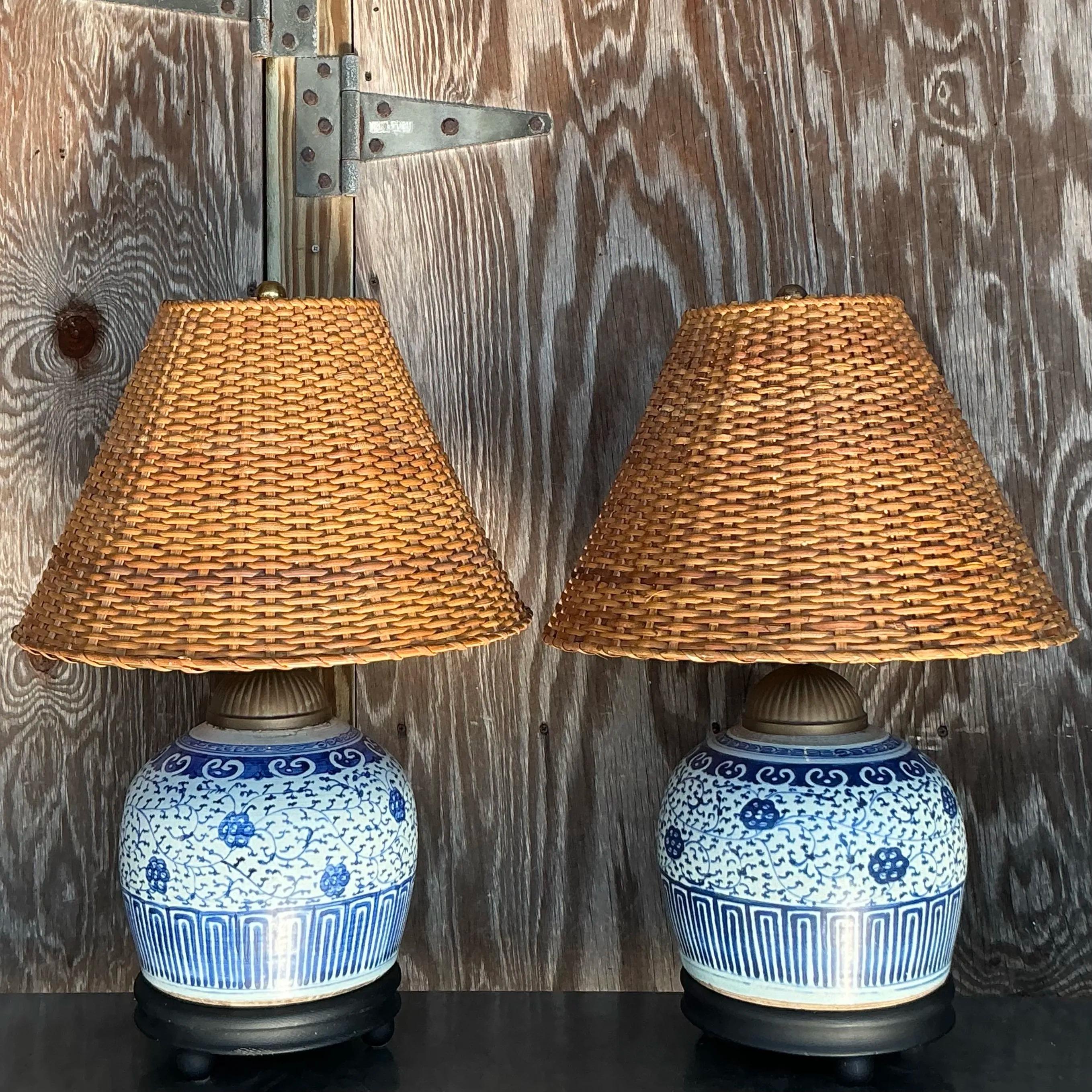 A striking pair of vintage Boho ceramic lamps in classic blue and white, paired with beautifully woven rattan shades. The bold ceramic bases feature timeless patterns, while the natural rattan adds warmth and texture. Perfect for creating a cozy,