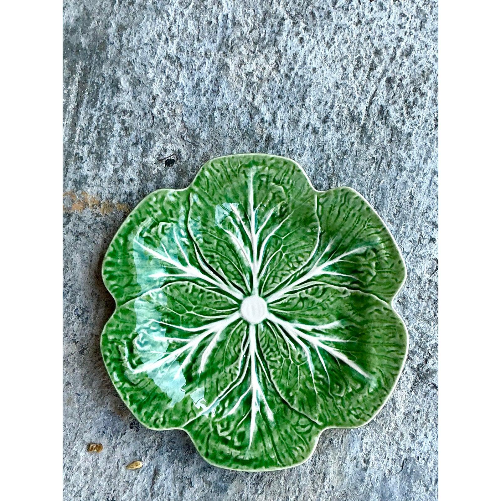Host your next gathering with unparalleled charm using this impressive set of fourteen vintage glazed ceramic plates from the celebrated Portuguese maker, Bordallo Pinheiro. Each plate is an iconic piece, expertly molded and richly glazed to capture
