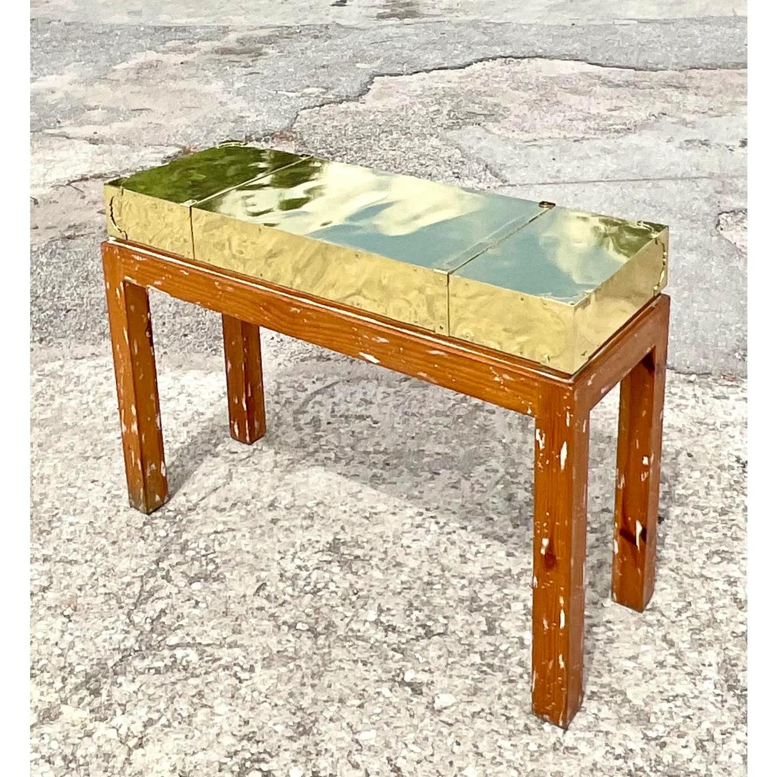 Fantastic vintage Boho console table. Beautiful brass box top on a cerused pine frame base. Perfectly polished top with faux straps and campaign corners. Acquired from a Palm Beach estate.
