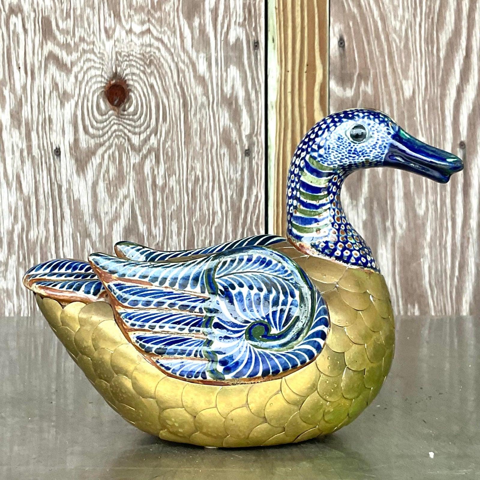 A fabulous vintage Boho sculpted metal duck. Areas of sculpted brass with parts of hand painted glazed ceramic. A chic addition to any space. Acquired from a Palm Beach estate.