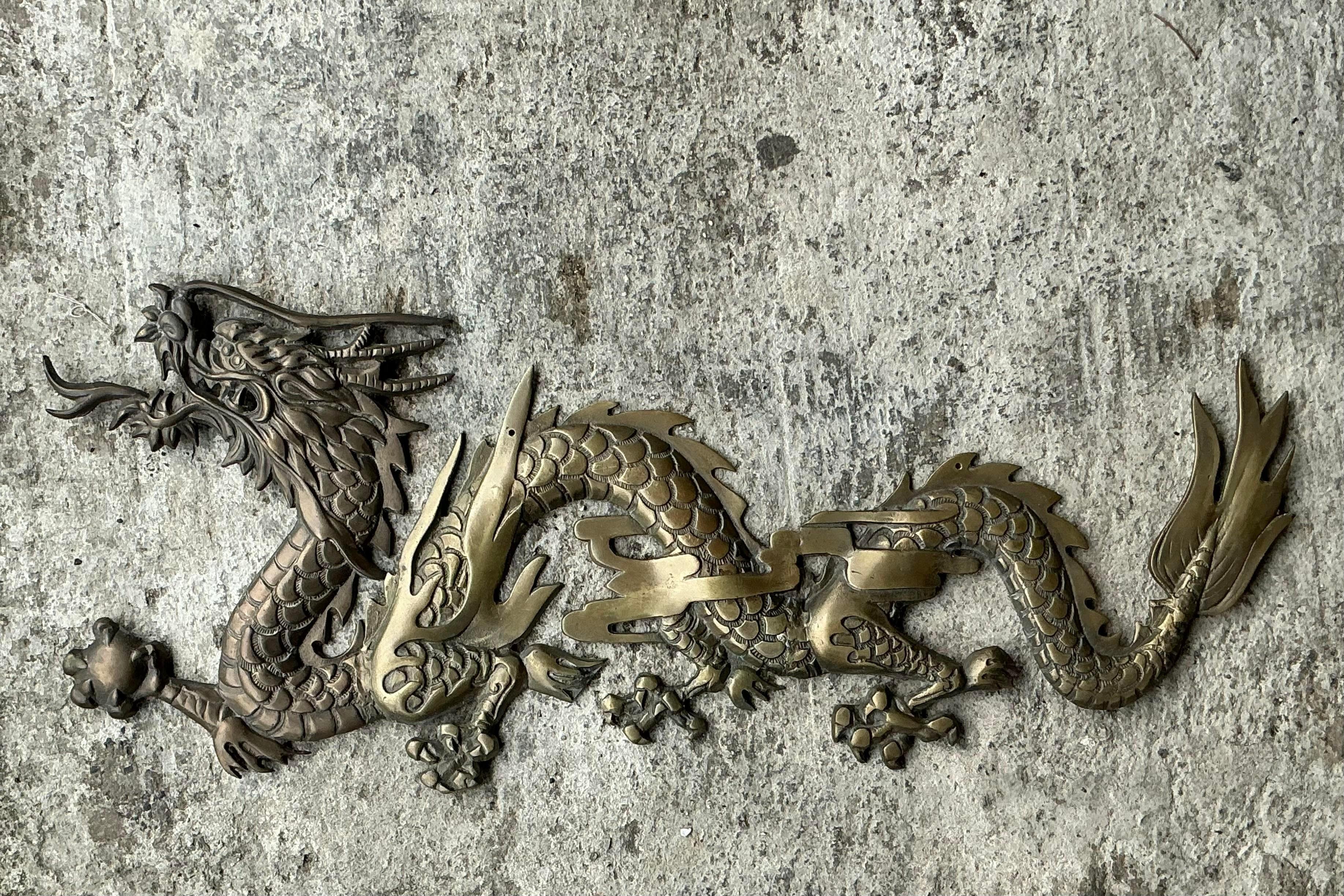 Elevate your space with our Vintage Boho Brass Dragon Wall Sculpture. This striking piece combines the boldness of brass with bohemian artistry, offering a captivating focal point that infuses any American decor with eclectic charm and mythical