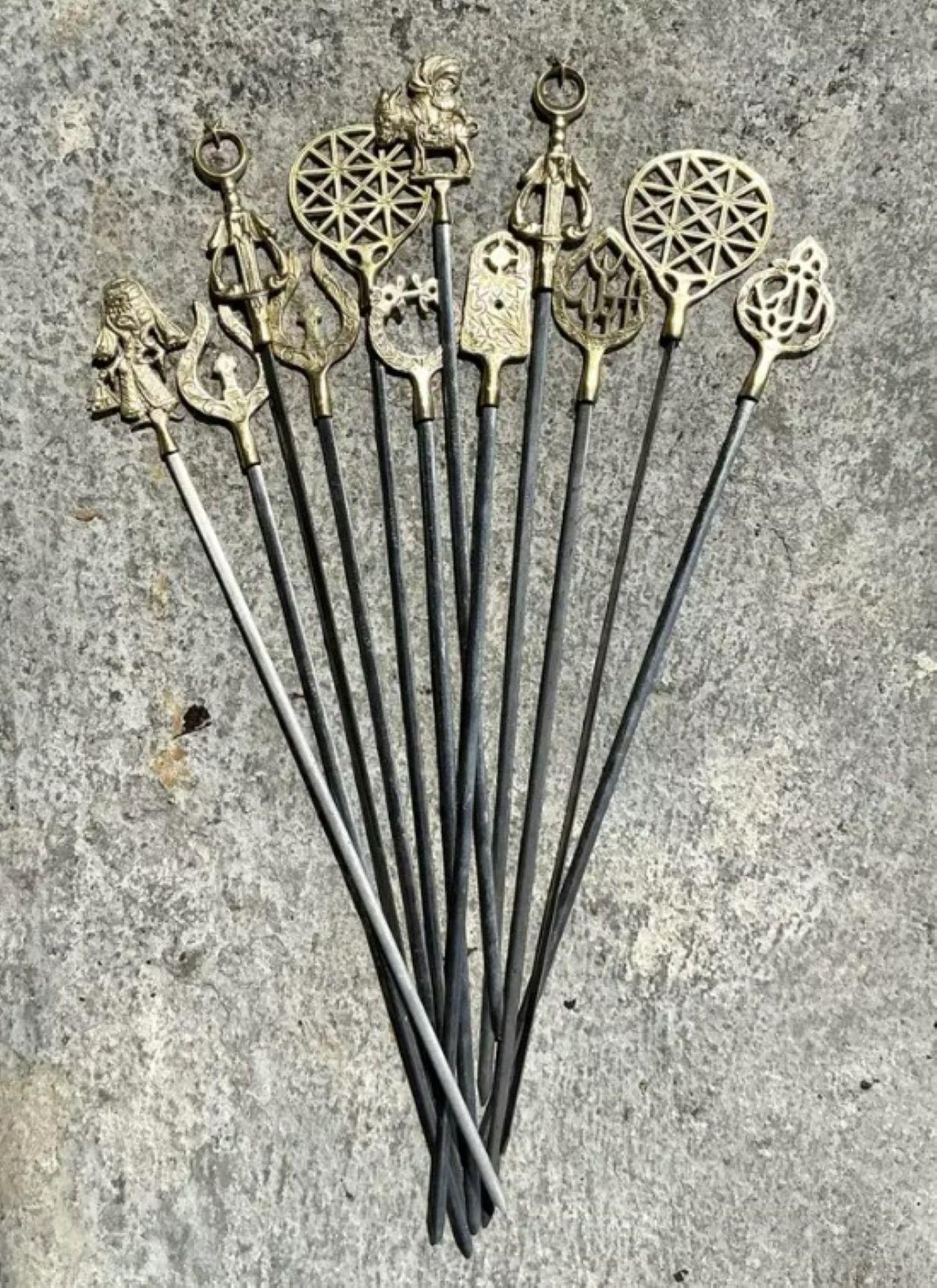 Add an eclectic and global touch to your serveware collection with this stunning set of 12 vintage brass character skewers. Each skewer is uniquely topped with a finely cast brass figure, including folkloric symbols, sacred emblems, animals, and