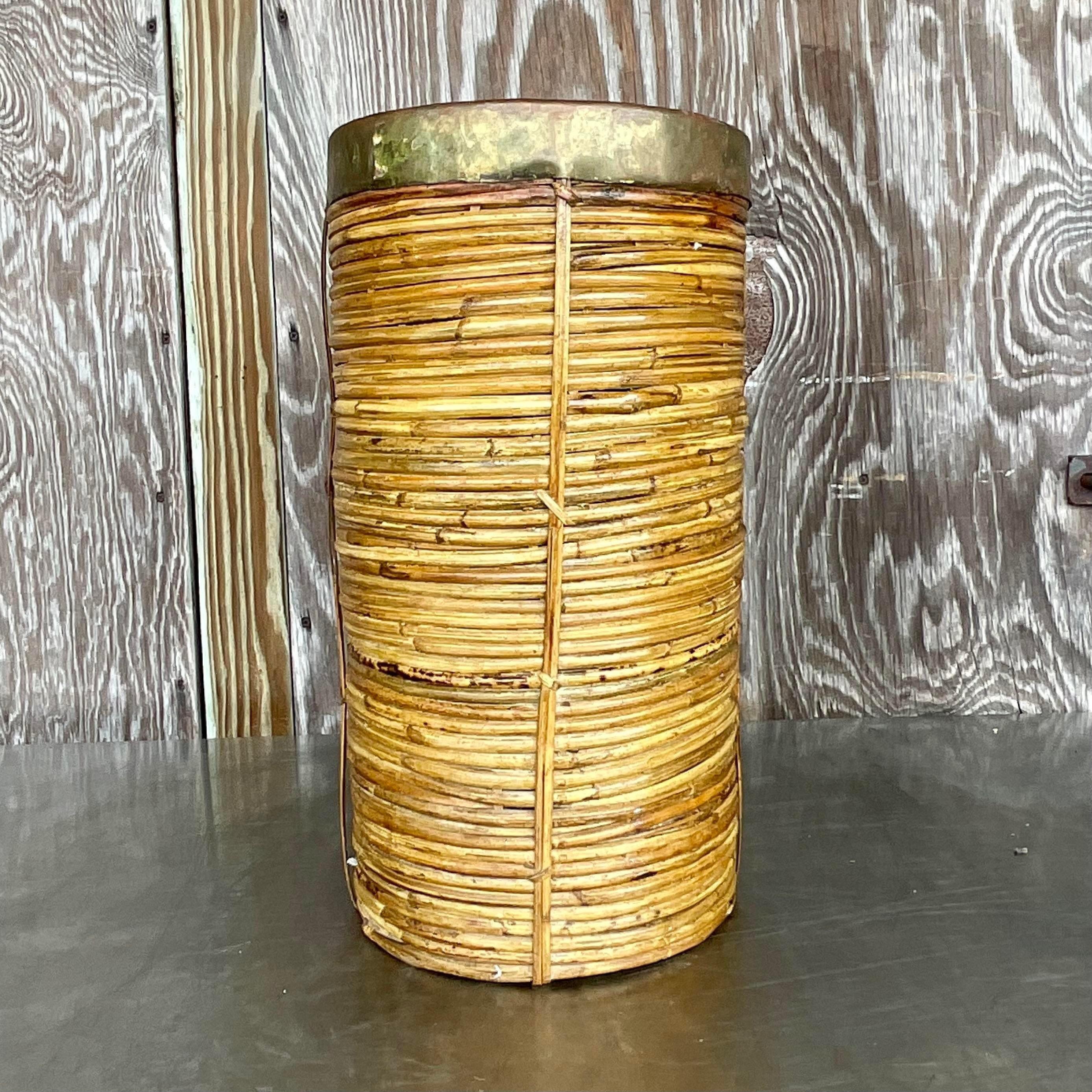 Elevate your entryway with a touch of American charm with our Vintage Boho Brass Rimmed Pencil Reed Umbrella Stand. Crafted with artisanal precision, this piece blends the warmth of natural materials with the classic appeal of brass detailing,