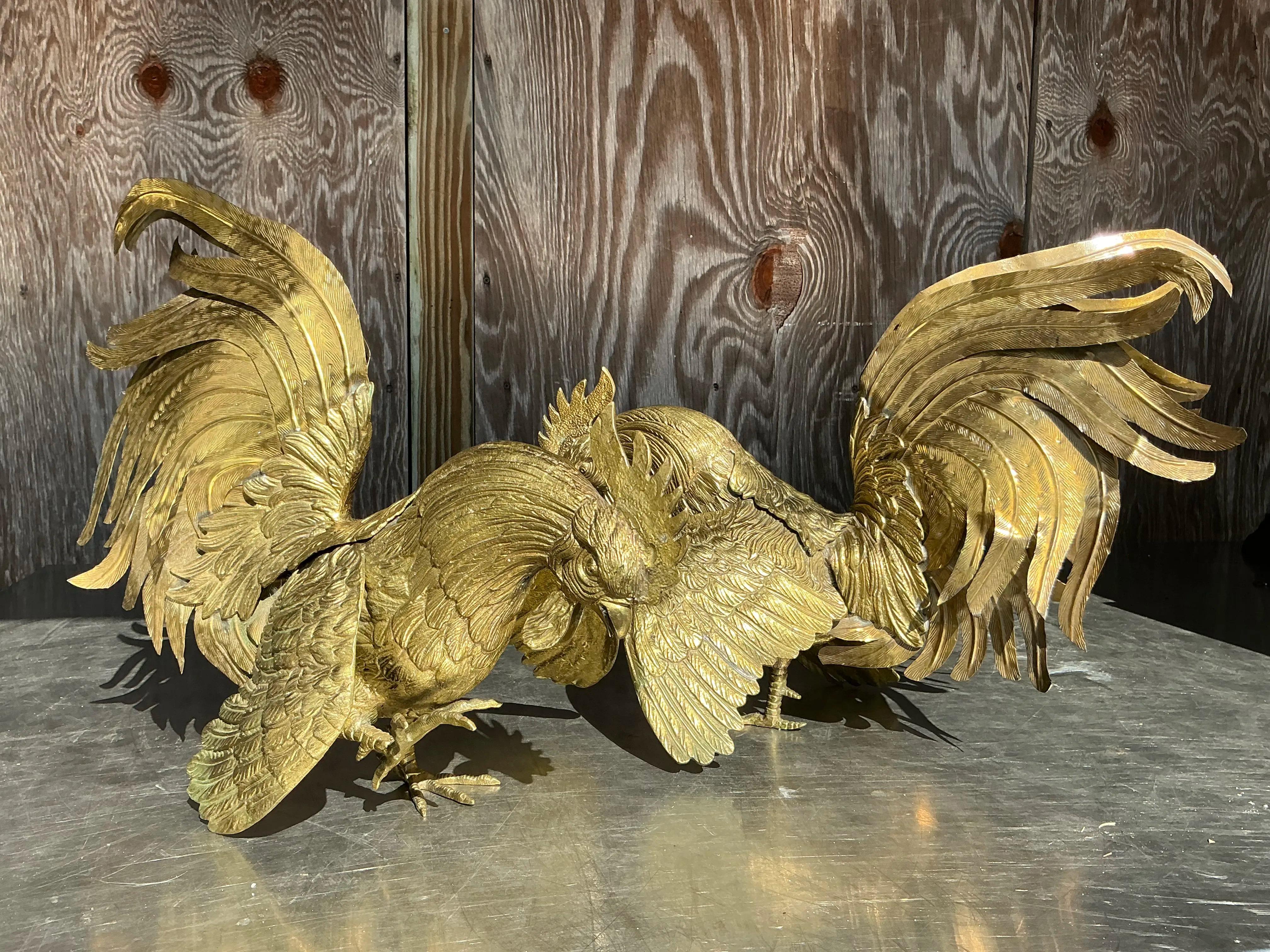 This striking pair of vintage monumental brass roosters exudes bold Bohemian charm and timeless sophistication. Each rooster is meticulously crafted with intricate details, from their expressive combs and feathers to their dynamic postures,