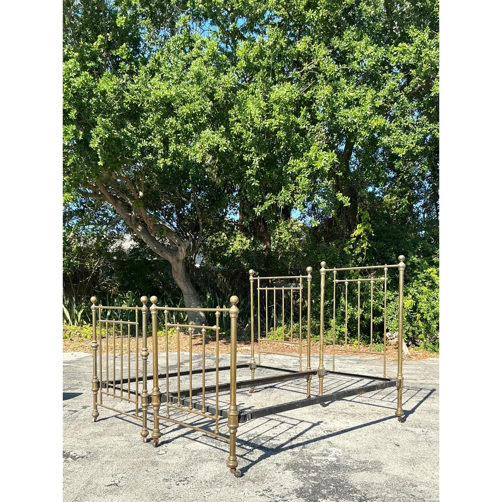 Elevate your bedroom with this stunning pair of vintage brass twin bed frames, exuding timeless elegance and refined craftsmanship. Featuring intricate spindle detailing, decorative finials, and a beautifully aged patina, these beds capture the